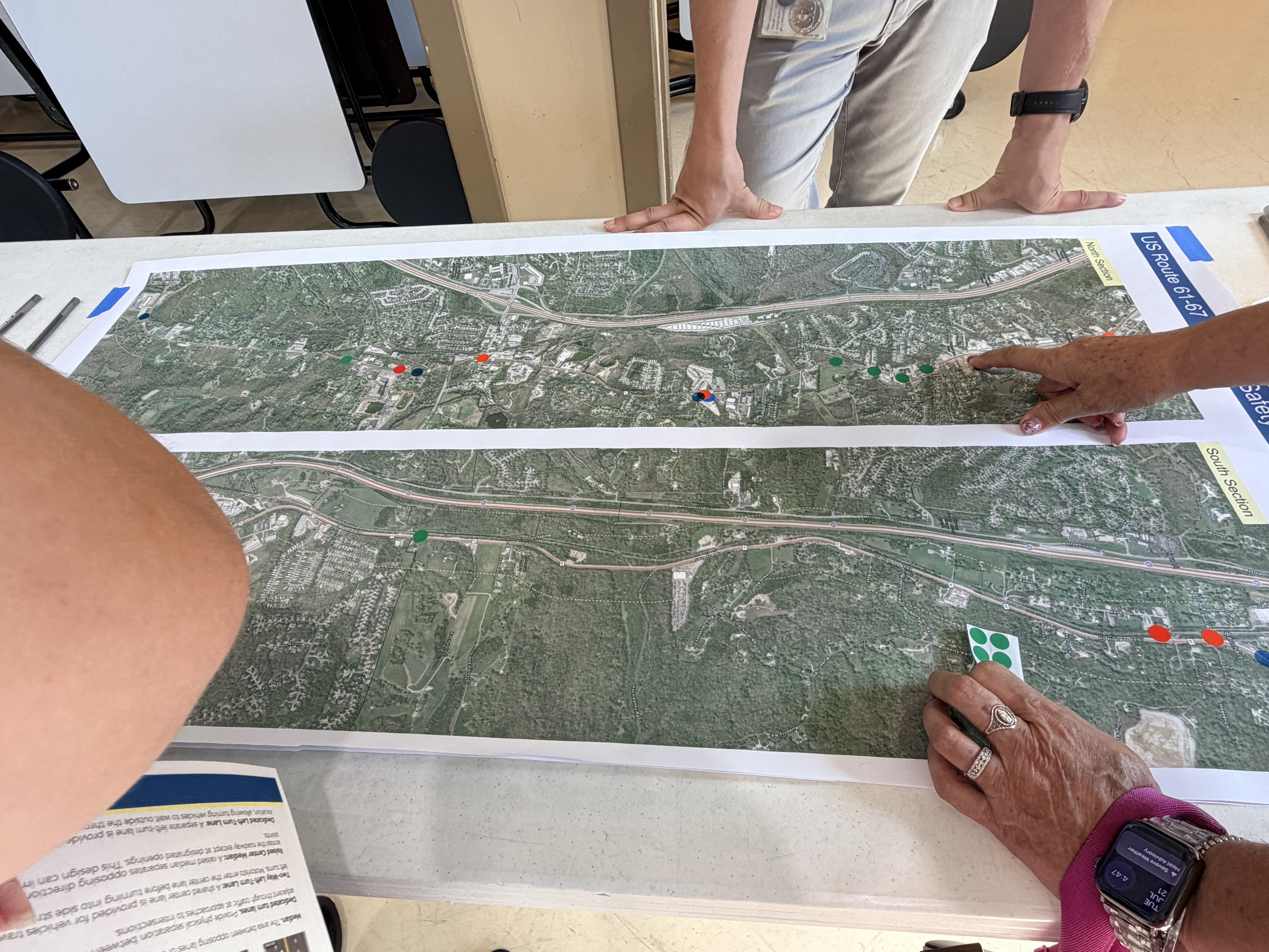 Residents marking locations on a Highway 61/67 corridor map during the MoDOT public meeting