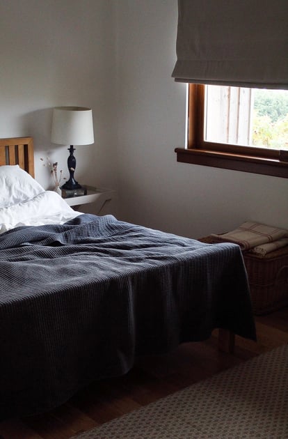 Cozy dark-toned bedroom with a countryside window at Guardswell Farm
