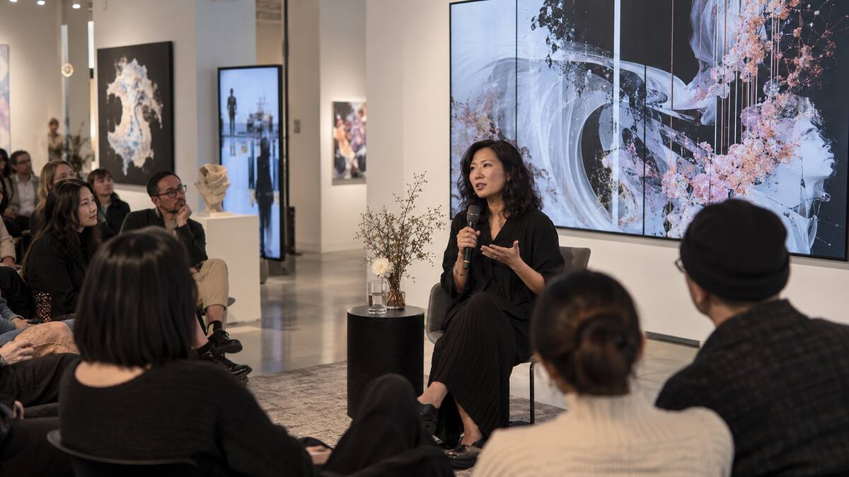 An artist speaking to an audience about art technology and motherhood at Richmond Art Gallery