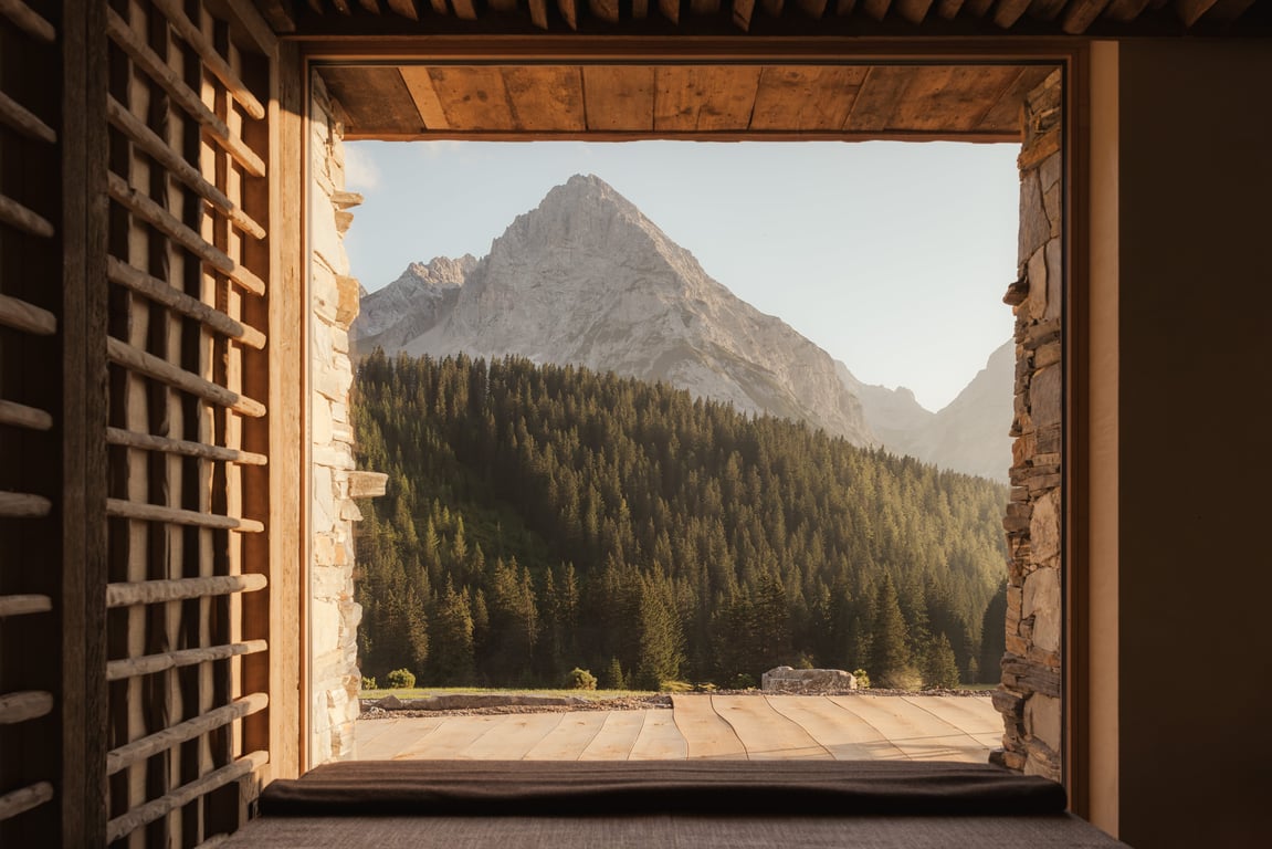 Mountain view framed by a deep wooden window at Eriro Hotel