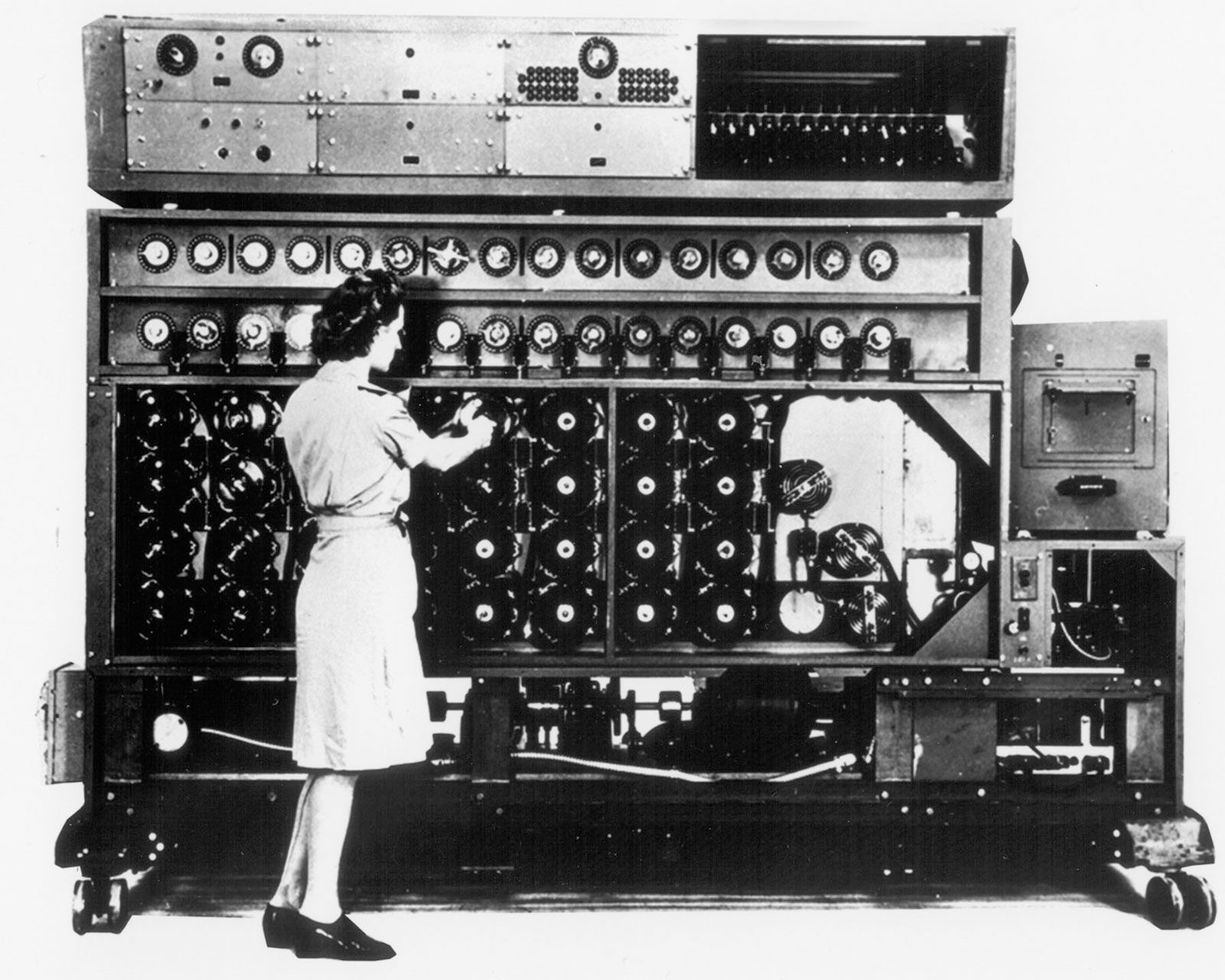 Historical black-and-white photograph of a woman operating a code-breaking machine, used on the LICM event page