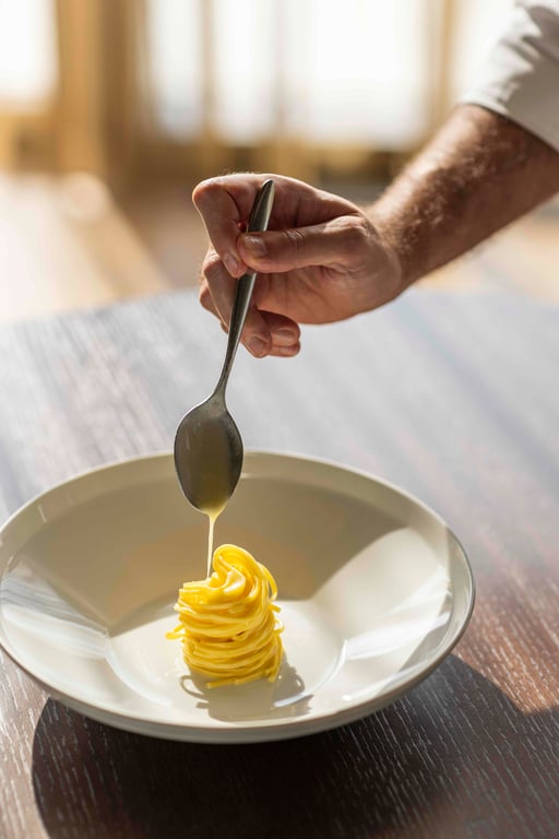Pasta being plated at Castelfalfi