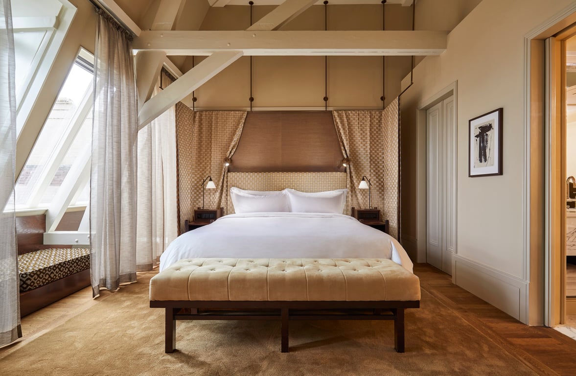 Guest bedroom with timber beams at Hotel De L’Europe Amsterdam