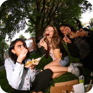 Friends eating at the Vegan Night Market in Vancouver