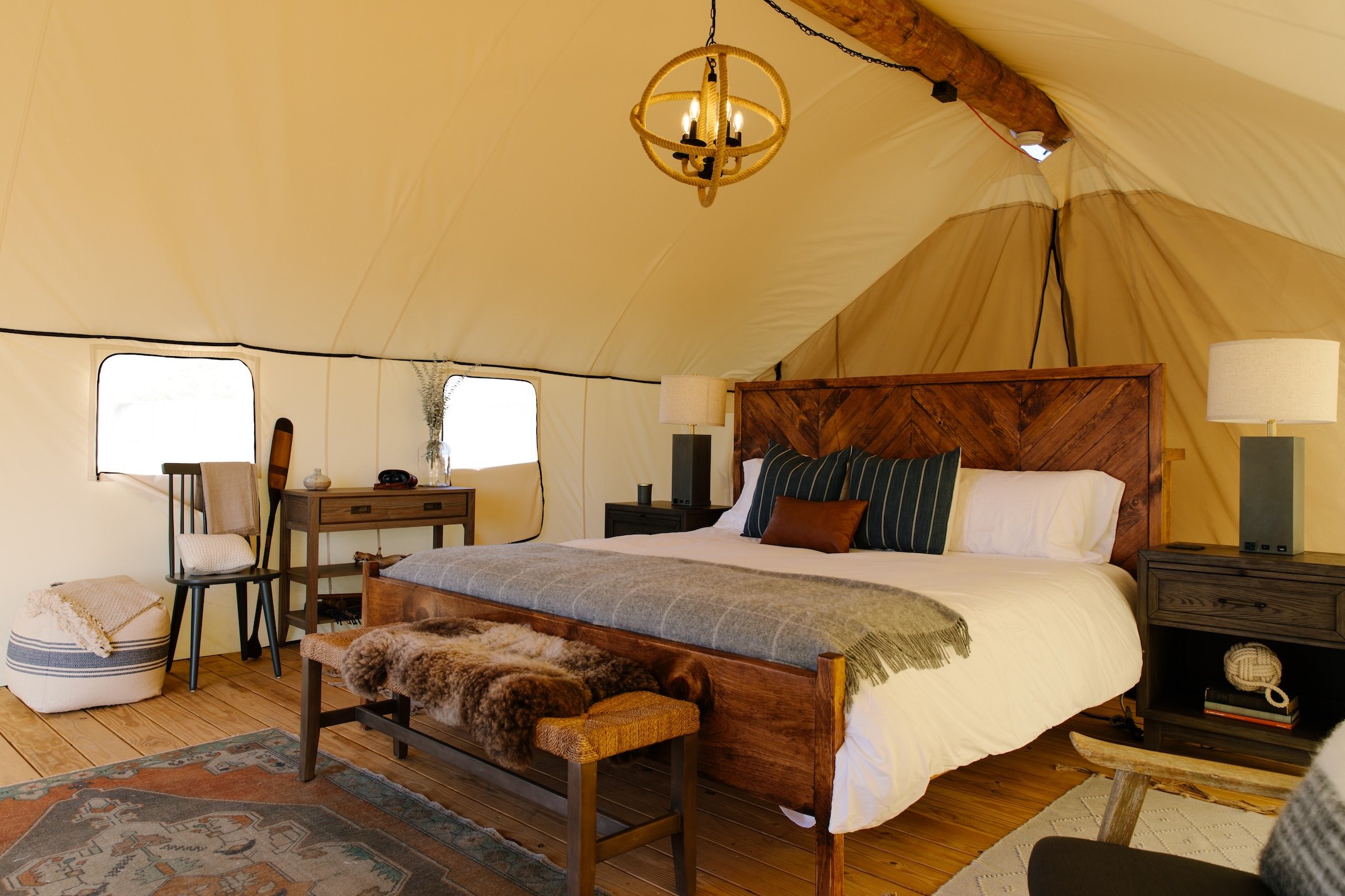 Guest bed inside a luxury canvas tent on Governors Island
