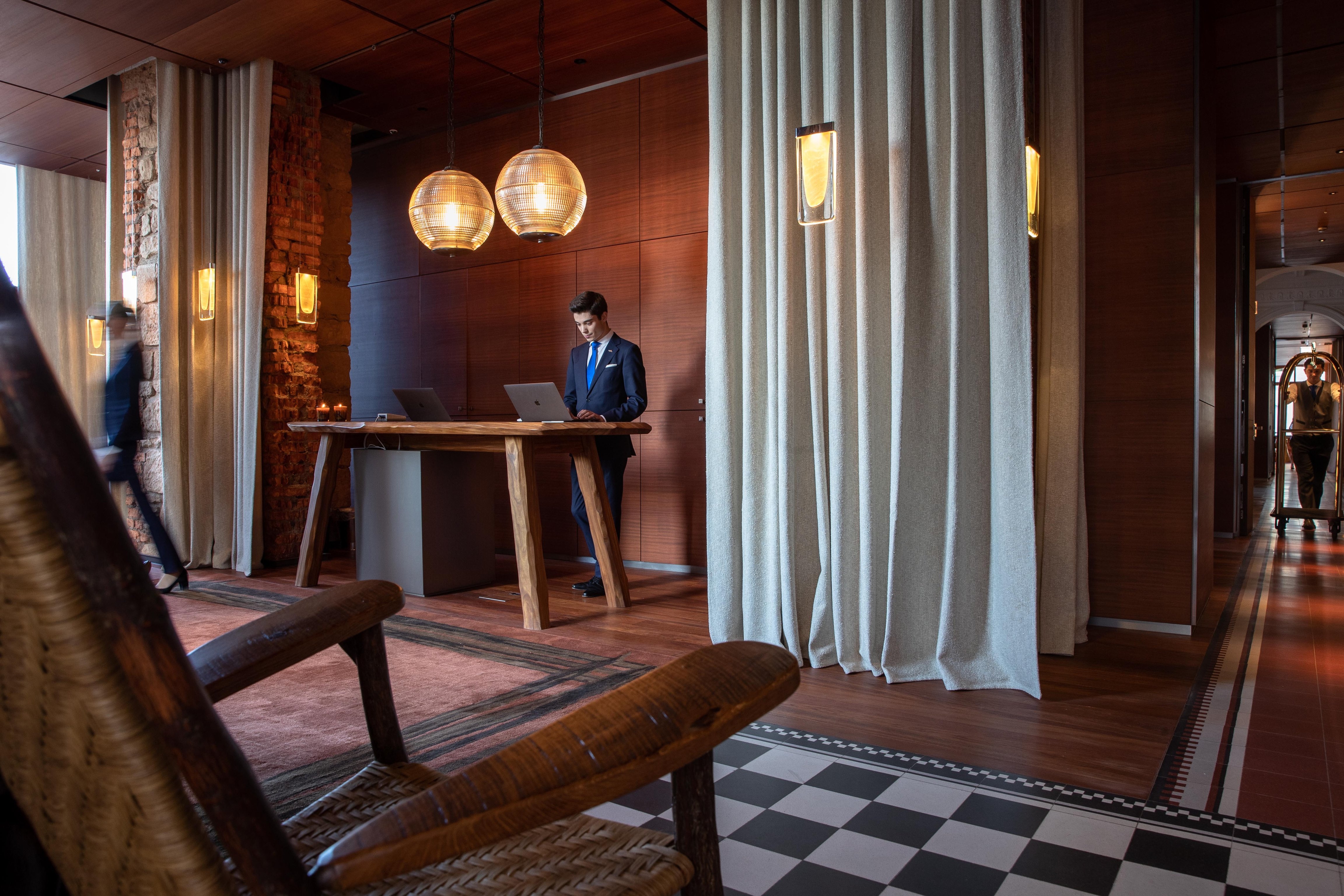Wood-paneled reception at La Réserve Eden au Lac