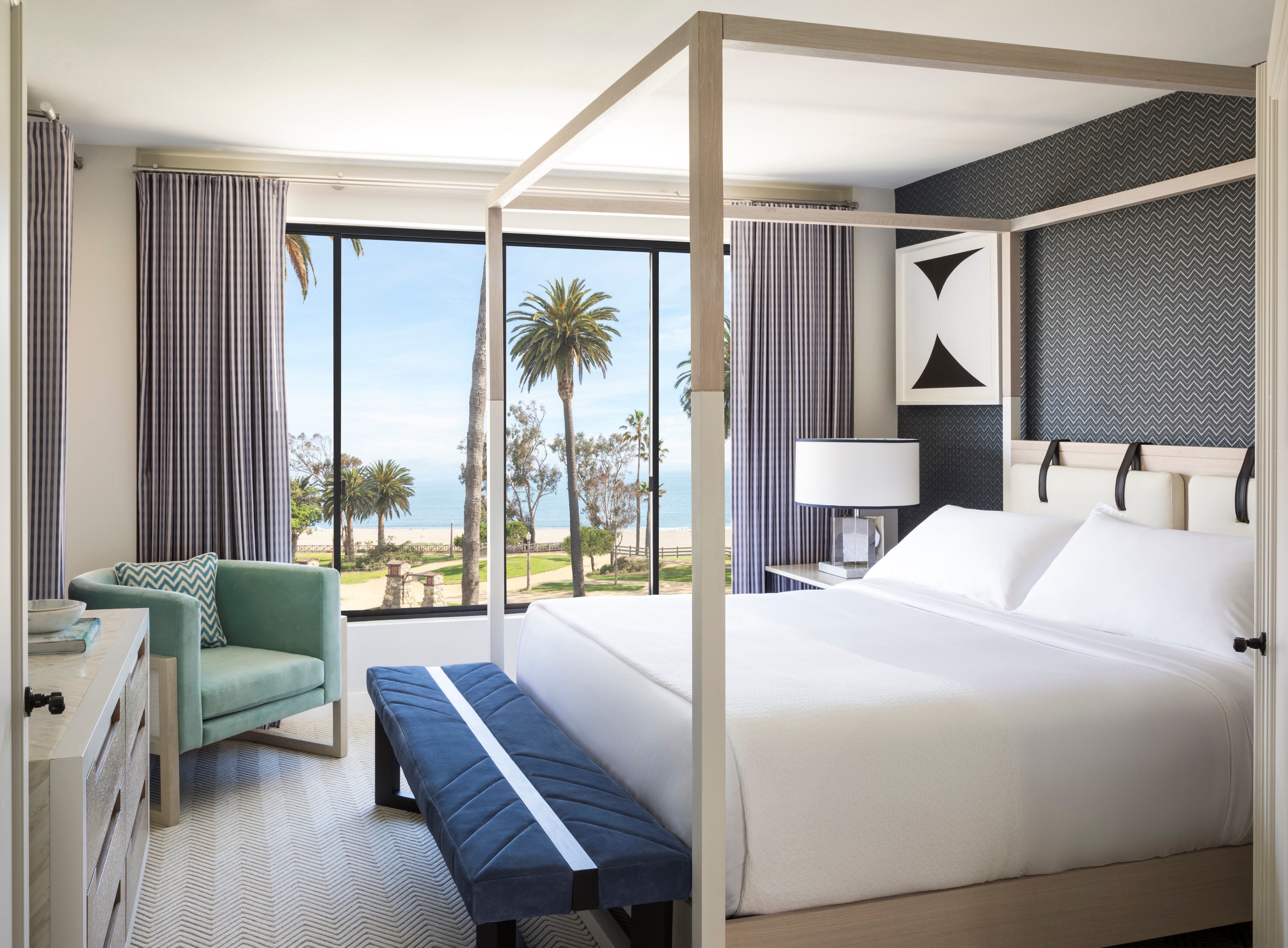 Ocean-view suite with a four-poster bed at Oceana