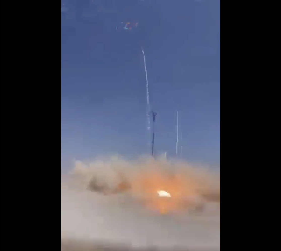 An explosion tearing through a military base as soldiers scatter, smoke looping unnaturally in the sky above