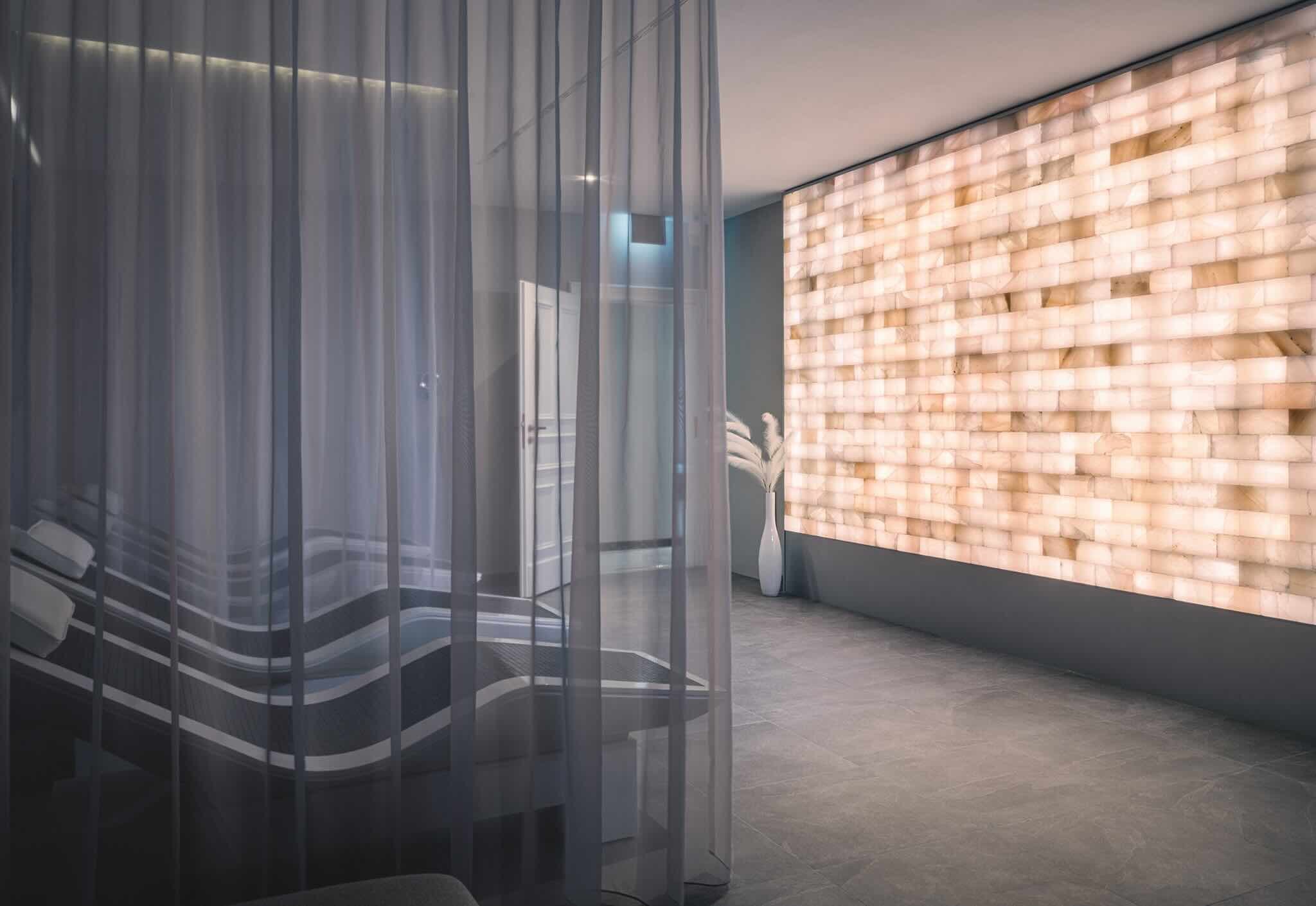 Spa relaxation area with an illuminated salt wall at Schloss Bensberg