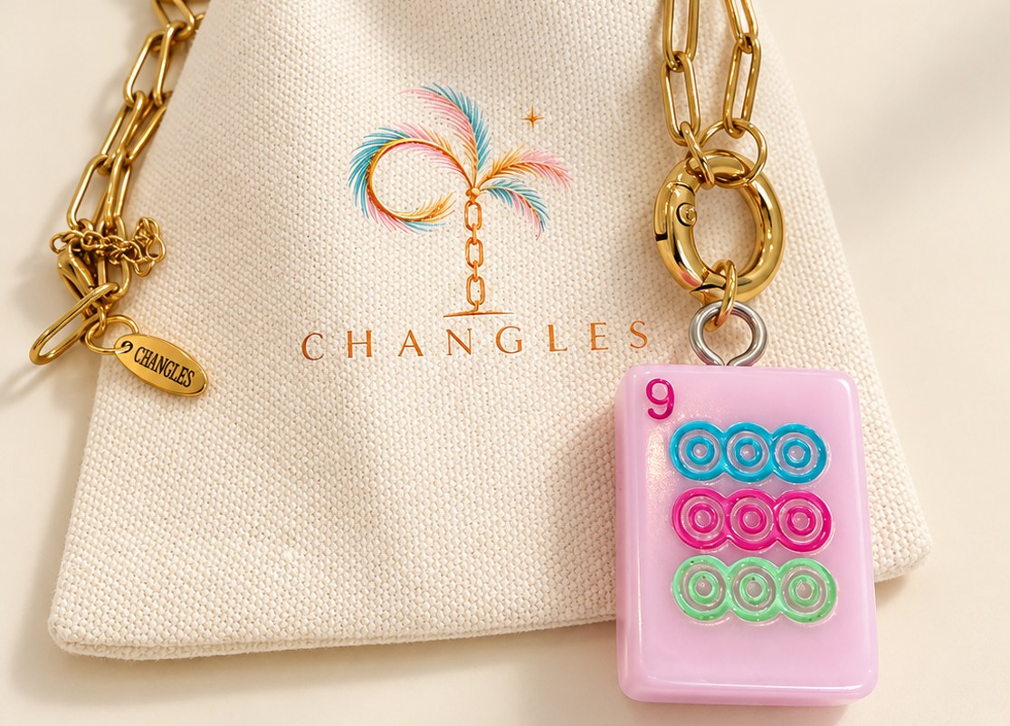 Changles 9 Dot mahjong tile necklace on a gold paperclip chain