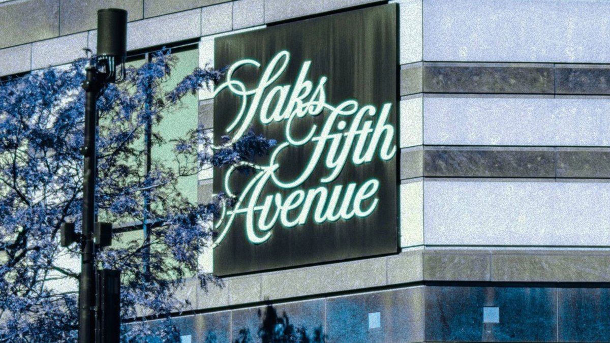 The Saks Fifth Avenue script logo on the corner of a store building