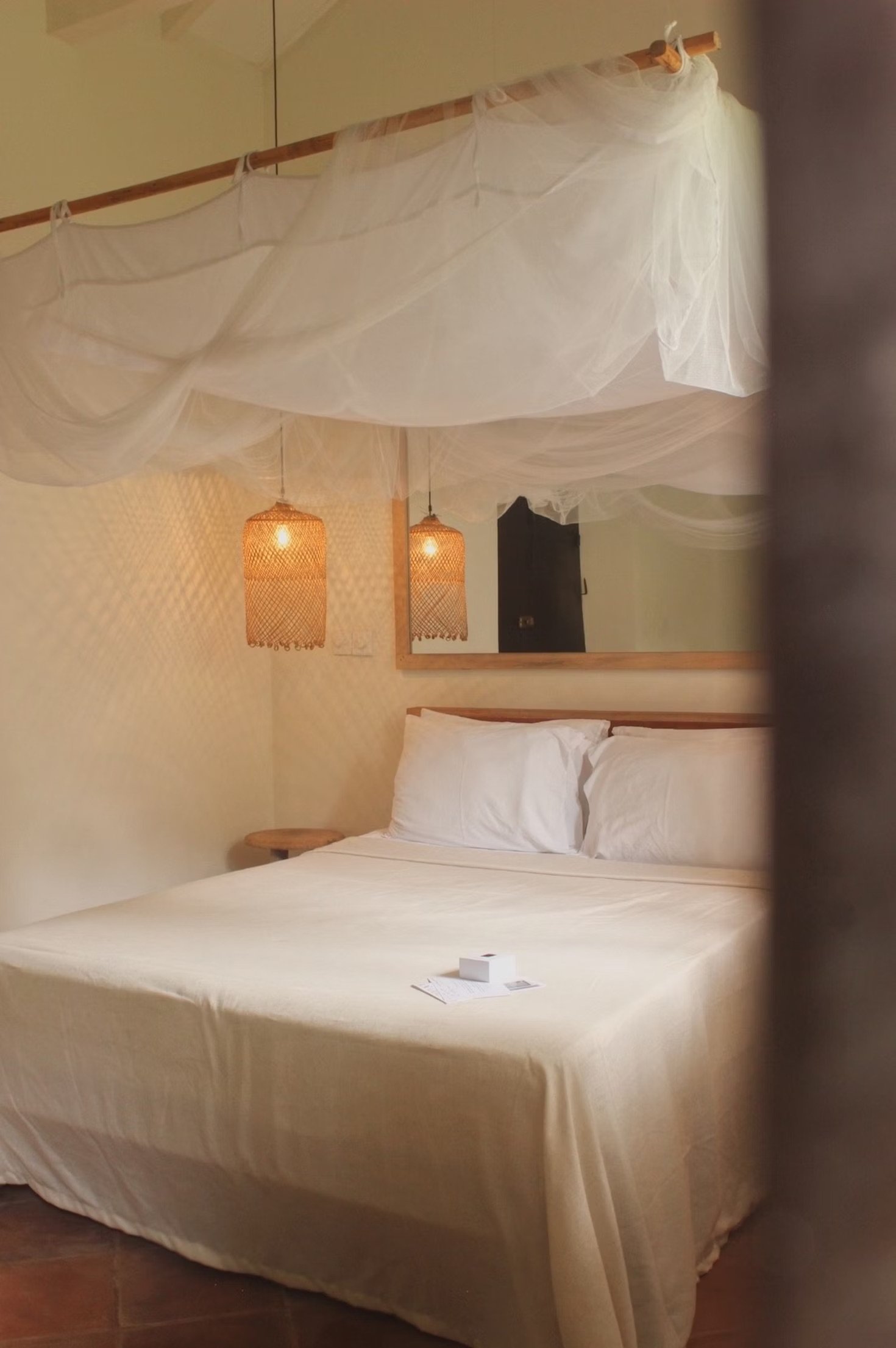 The Kip bedroom with a mosquito net and natural linens