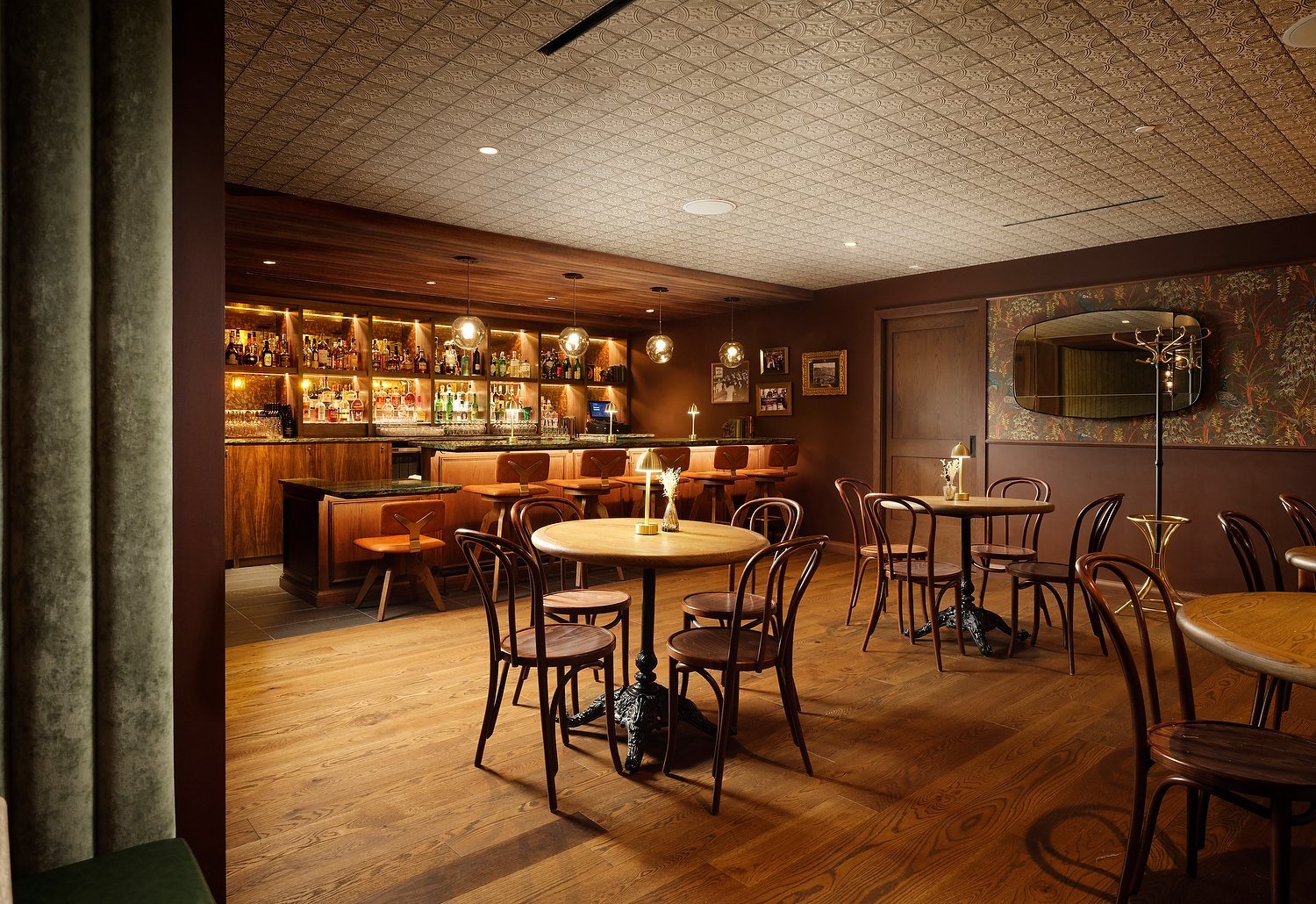 Warm wood interior of the Canary speakeasy at Hotel Alpenrock Breckenridge