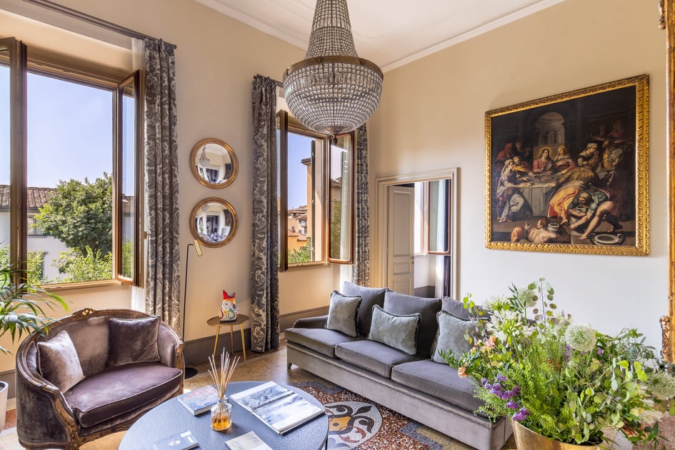 Art-filled apartment living room with tall windows