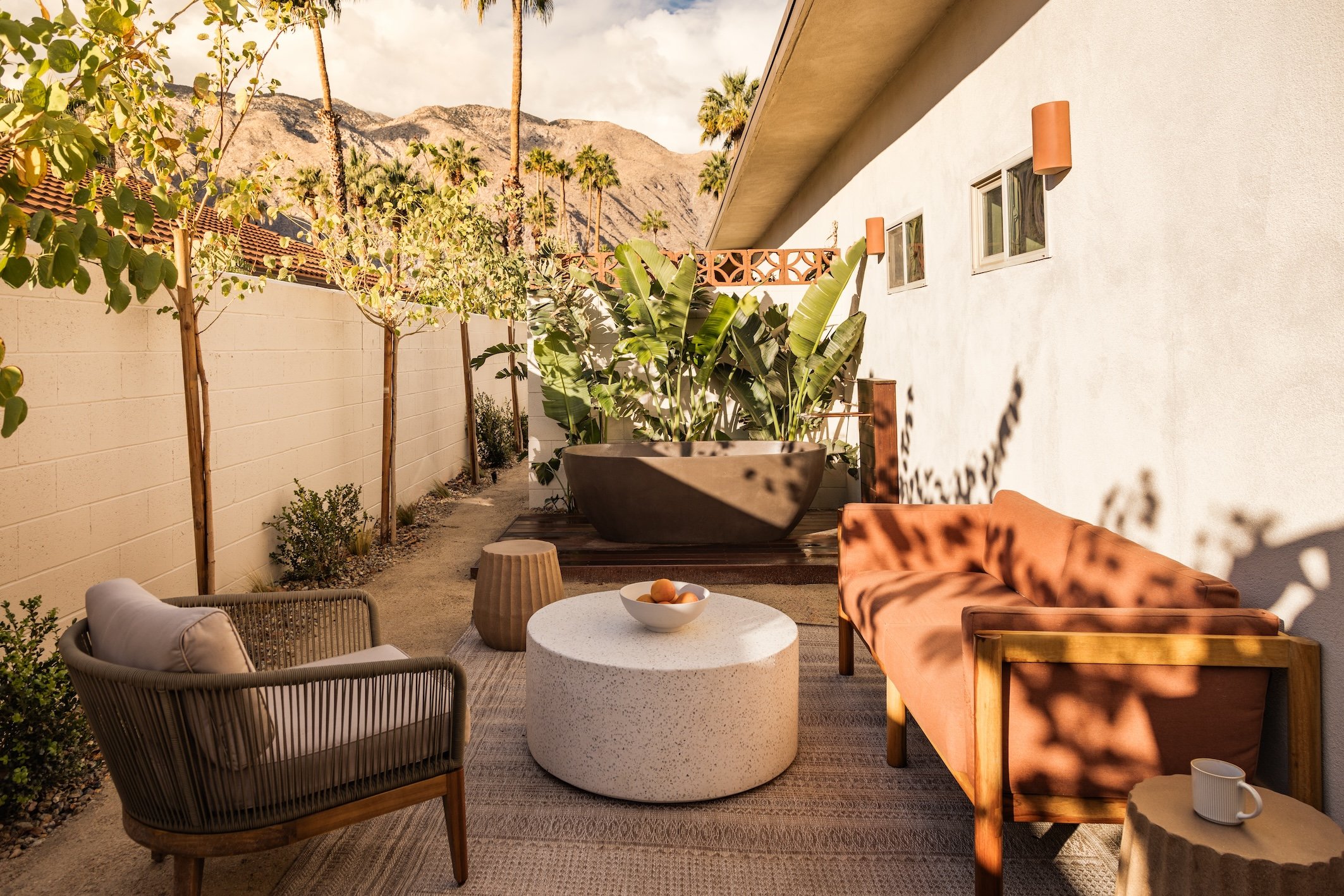 Private patio with a hot tub and outdoor seating at Terra Palm Springs