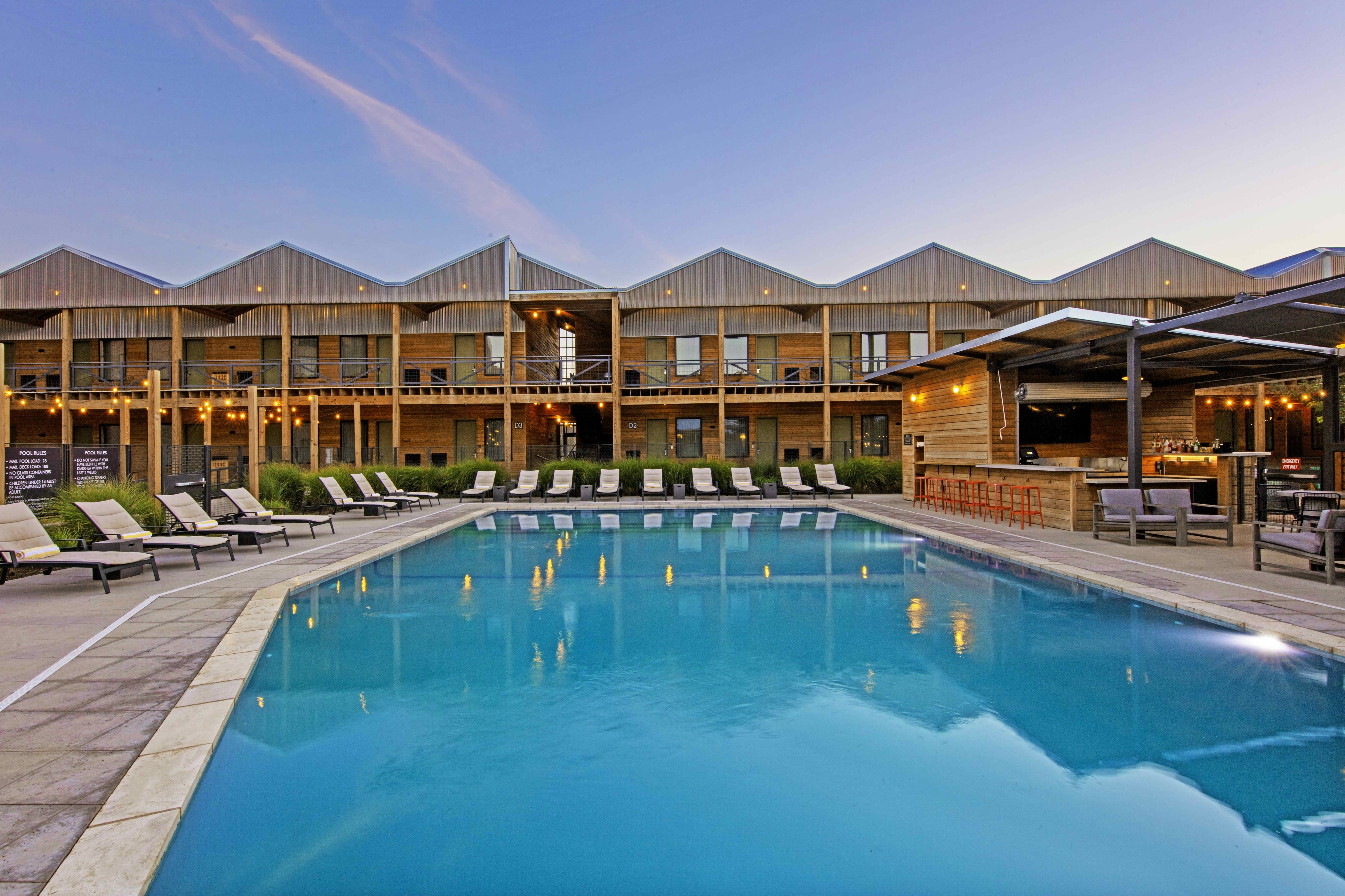 Outdoor swimming pool framed by Cotton Court Hotel guest rooms