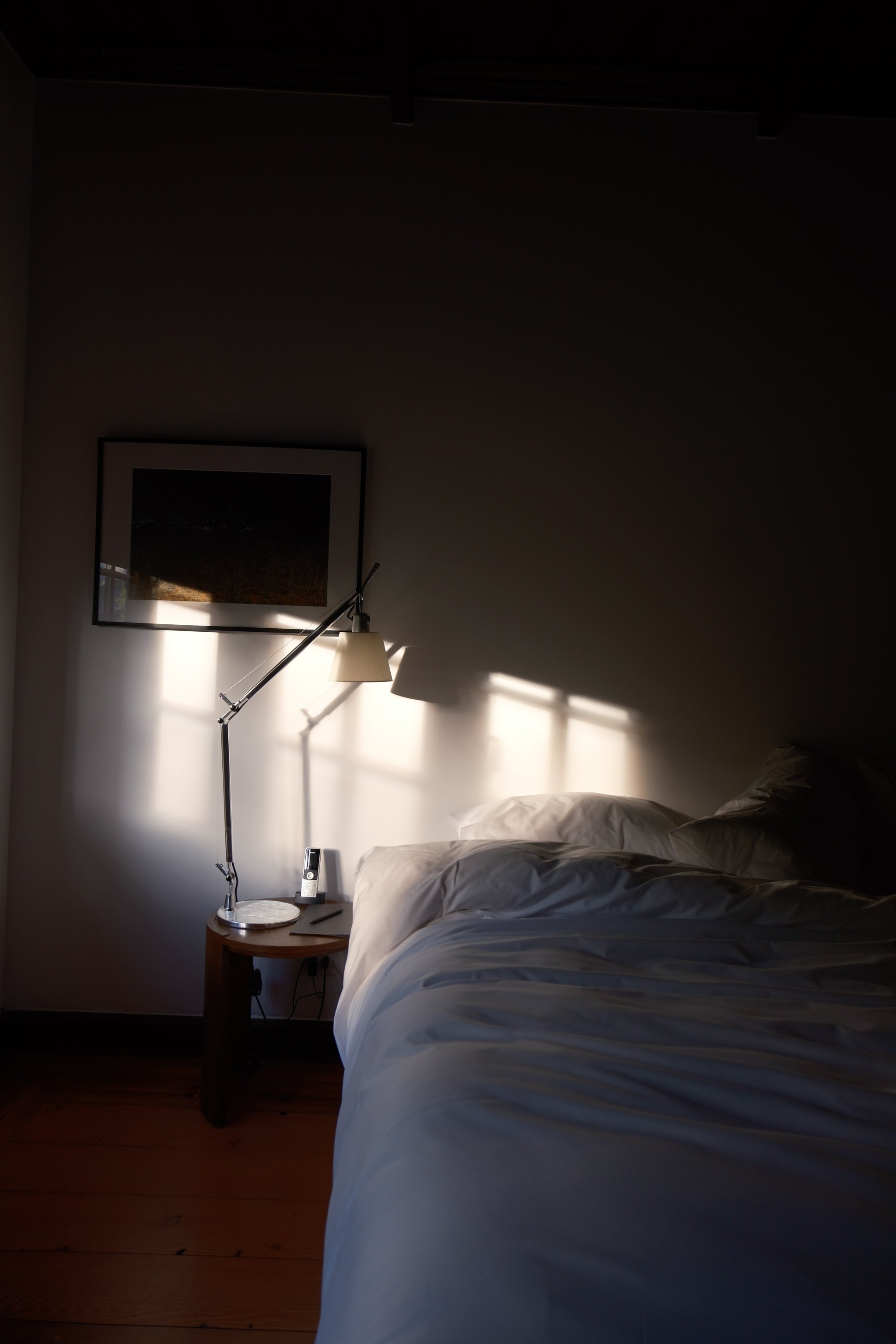 Sunlit guest bed at Explora Patagonia National Park Lodge