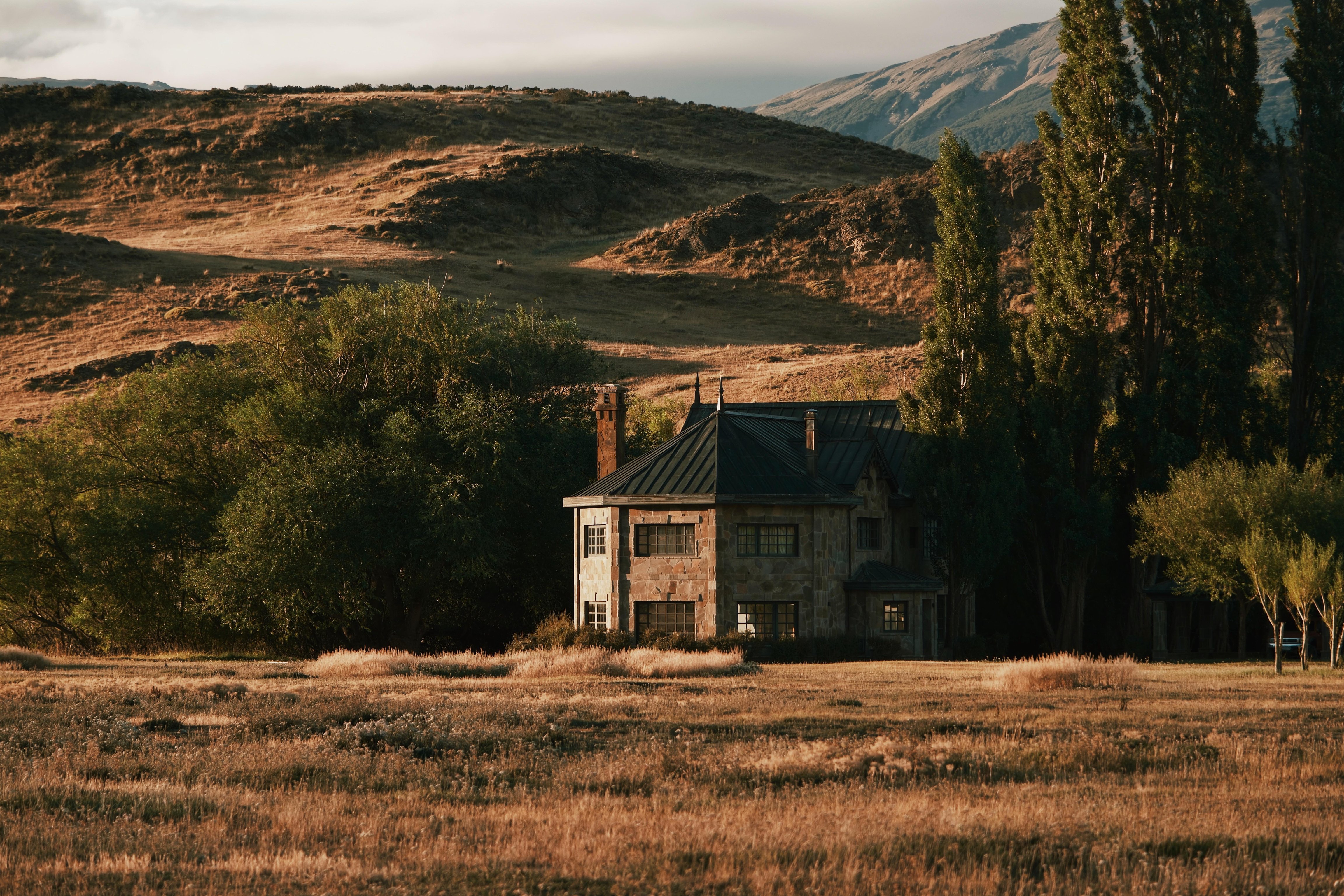 Stone lodge building beneath the hills of Patagonia National Park
