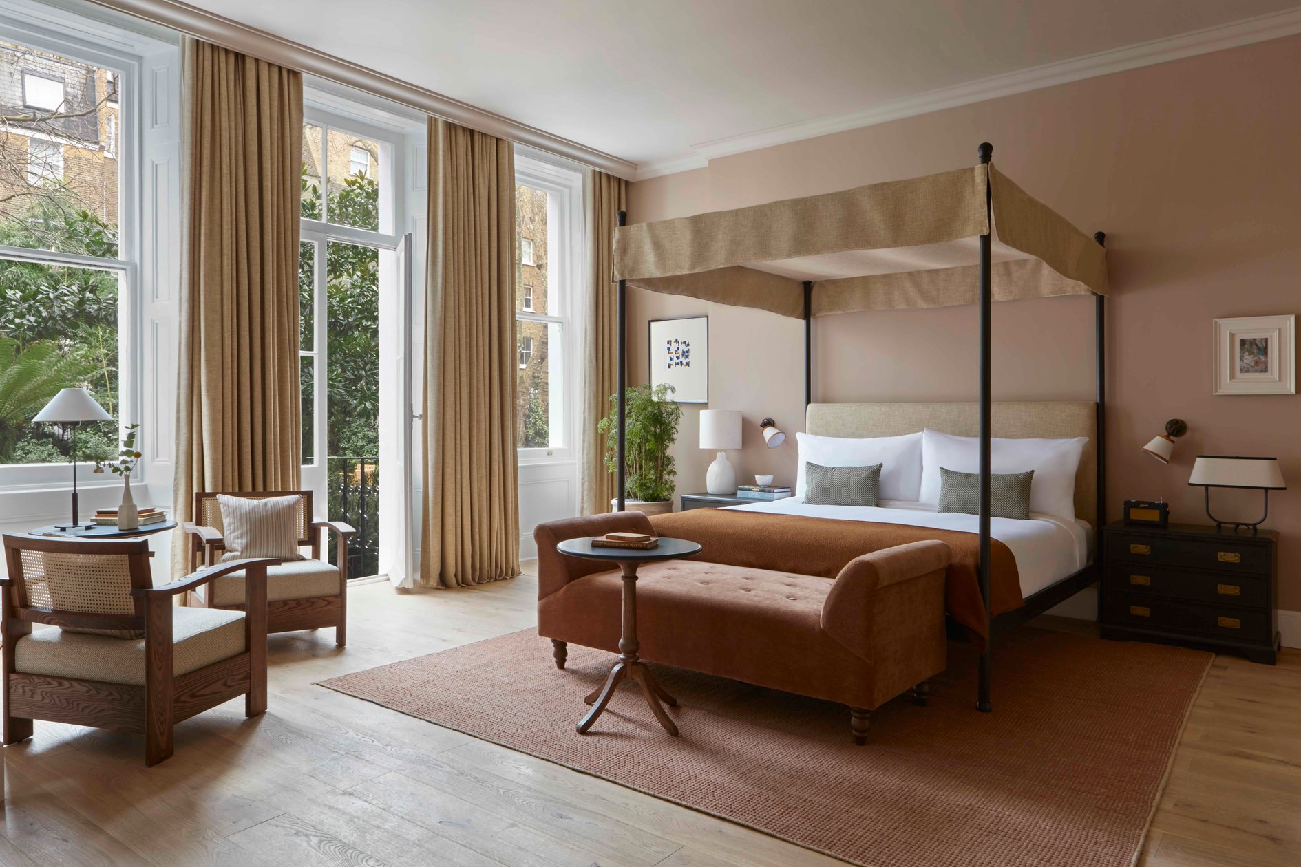 Four-poster guest bed and tall windows at Templeton Garden