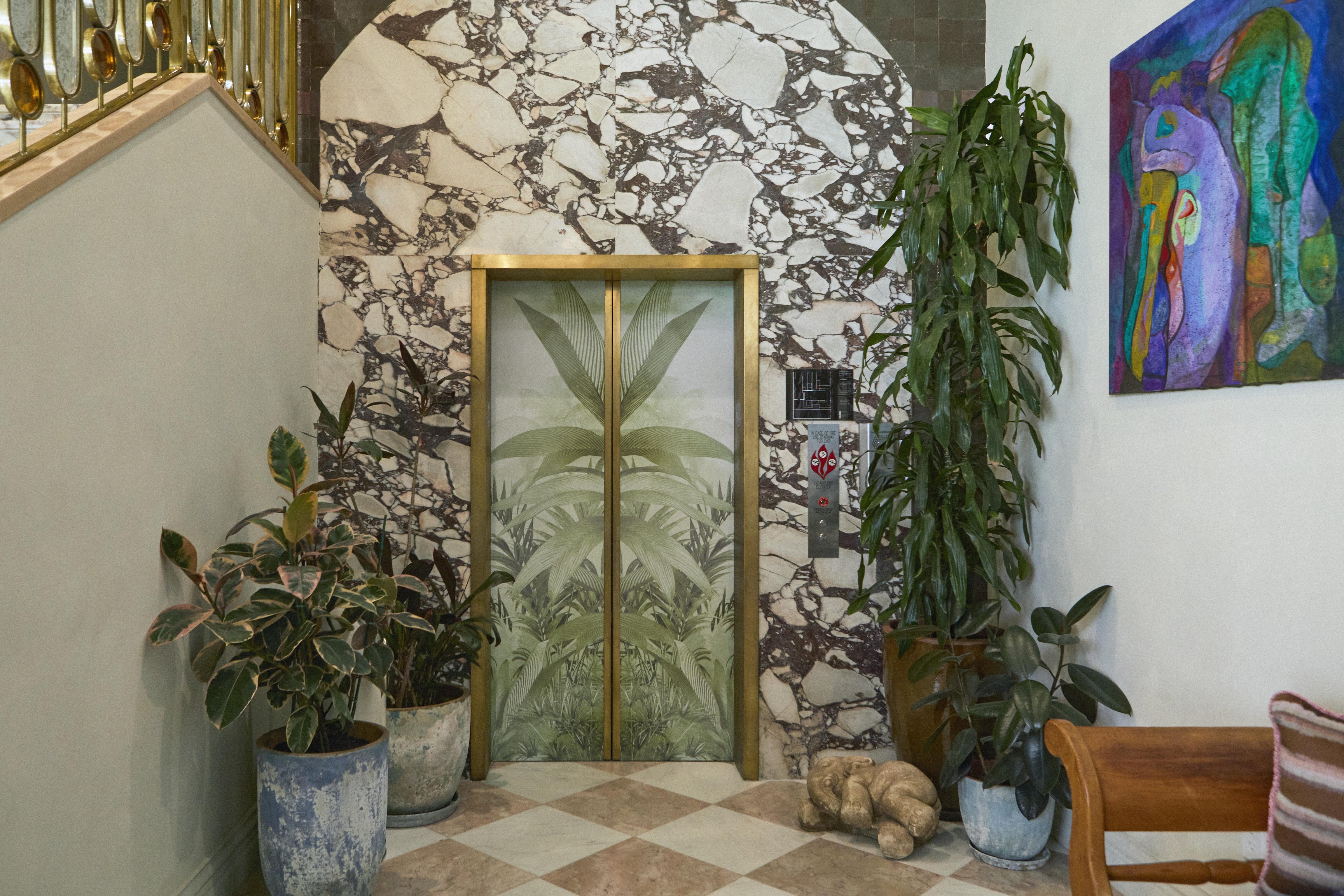 Patterned walls and gold-framed elevator at Granger Hotel