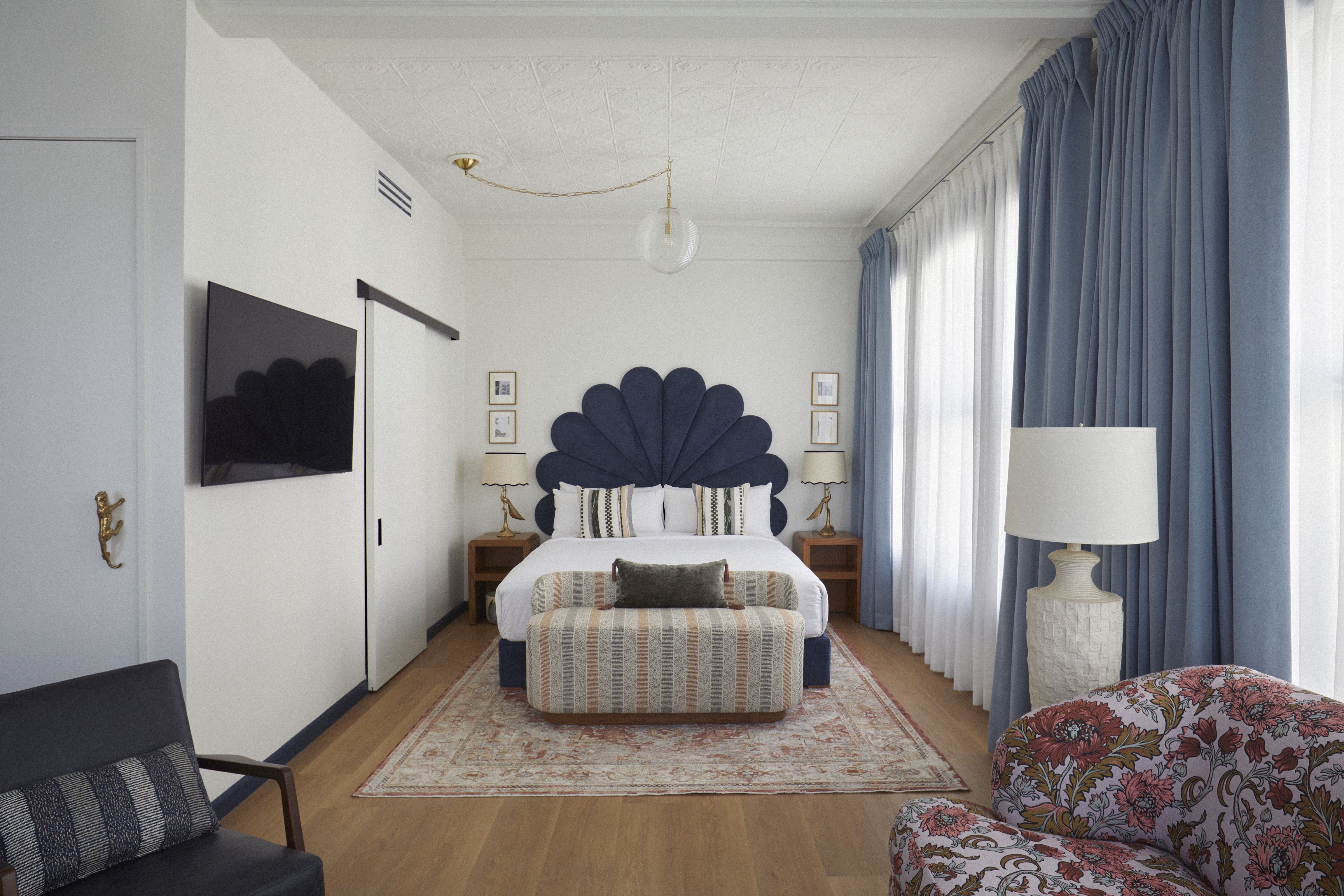 Granger Hotel guest room with a fan-shaped headboard and tall windows