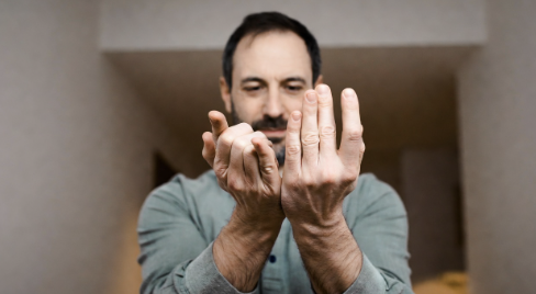 Man squeezing and releasing his hands to improve grip strength