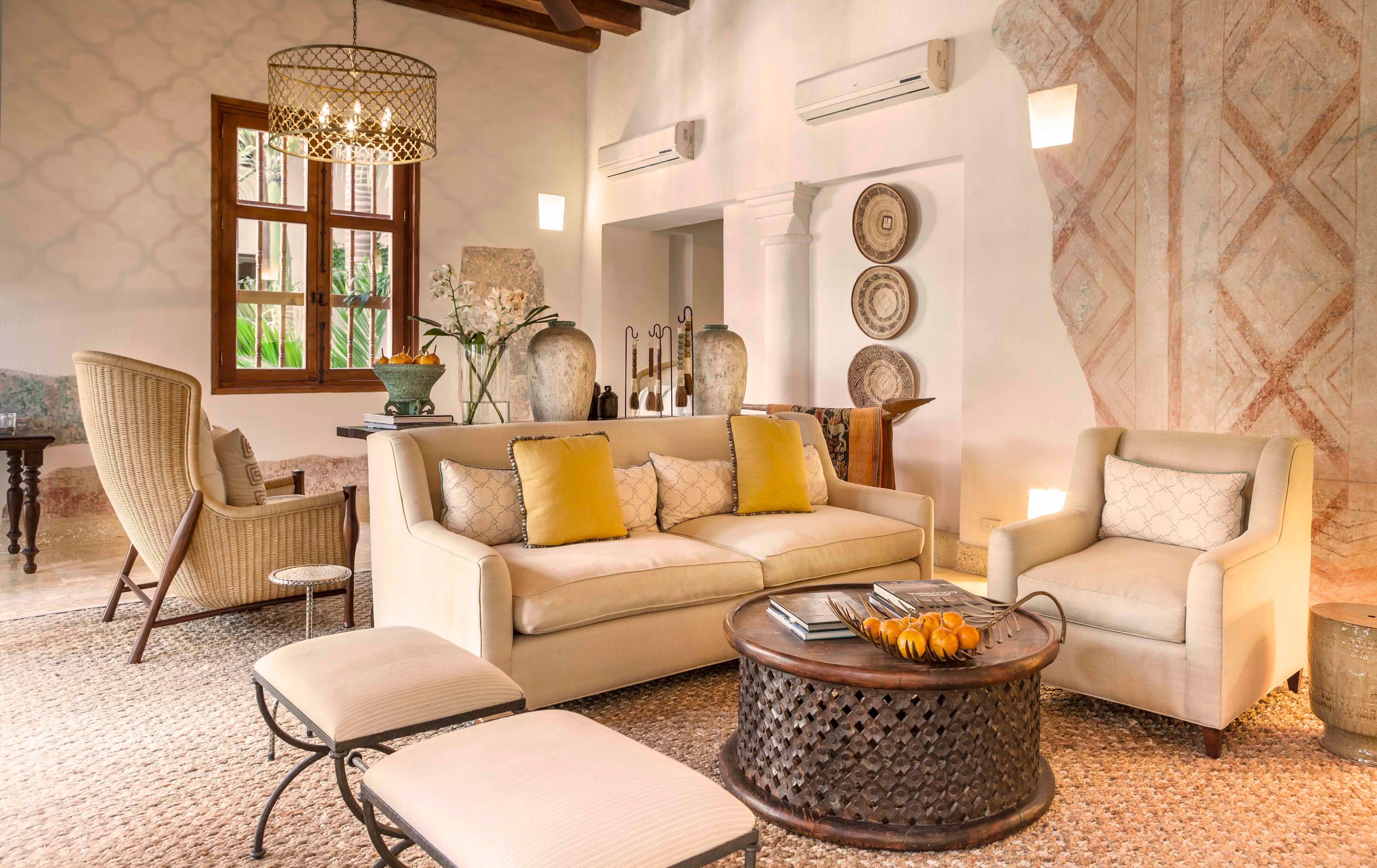 Casa San Agustín sitting room with cream sofas and yellow cushions
