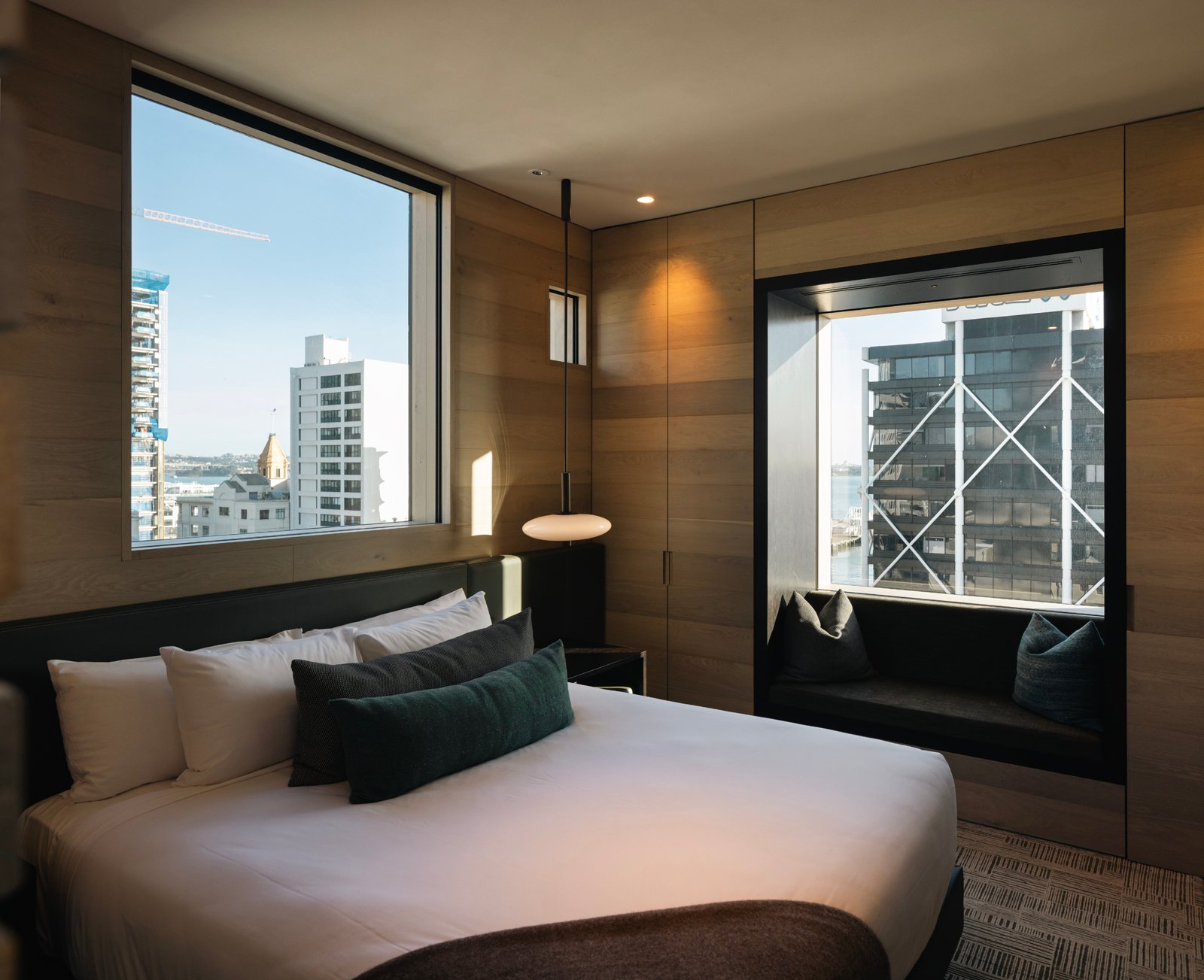 Window-side seating and city views in a Hotel Britomart room