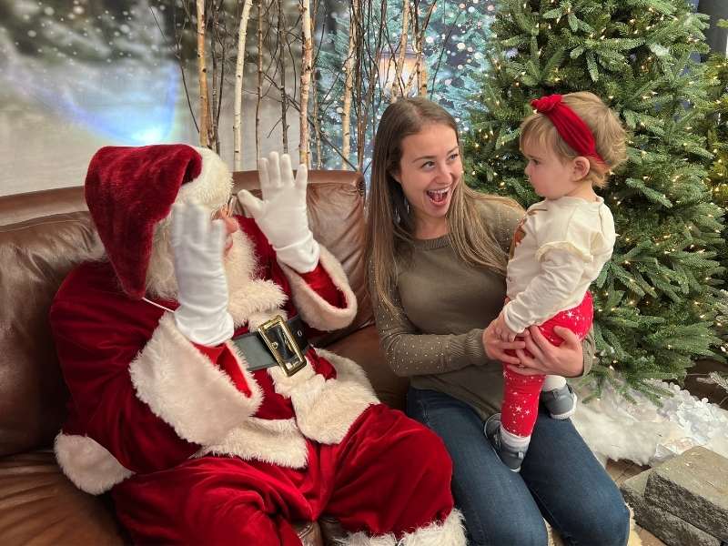 Santa with visitors in a promotional photograph from Hicks Nurseries.