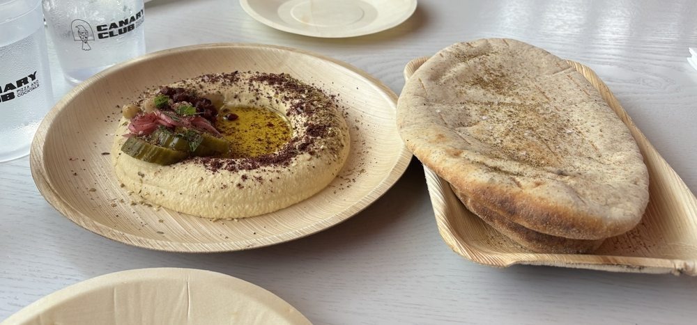 Wood-fired oven and dining space at Canary Club in Bonita Springs