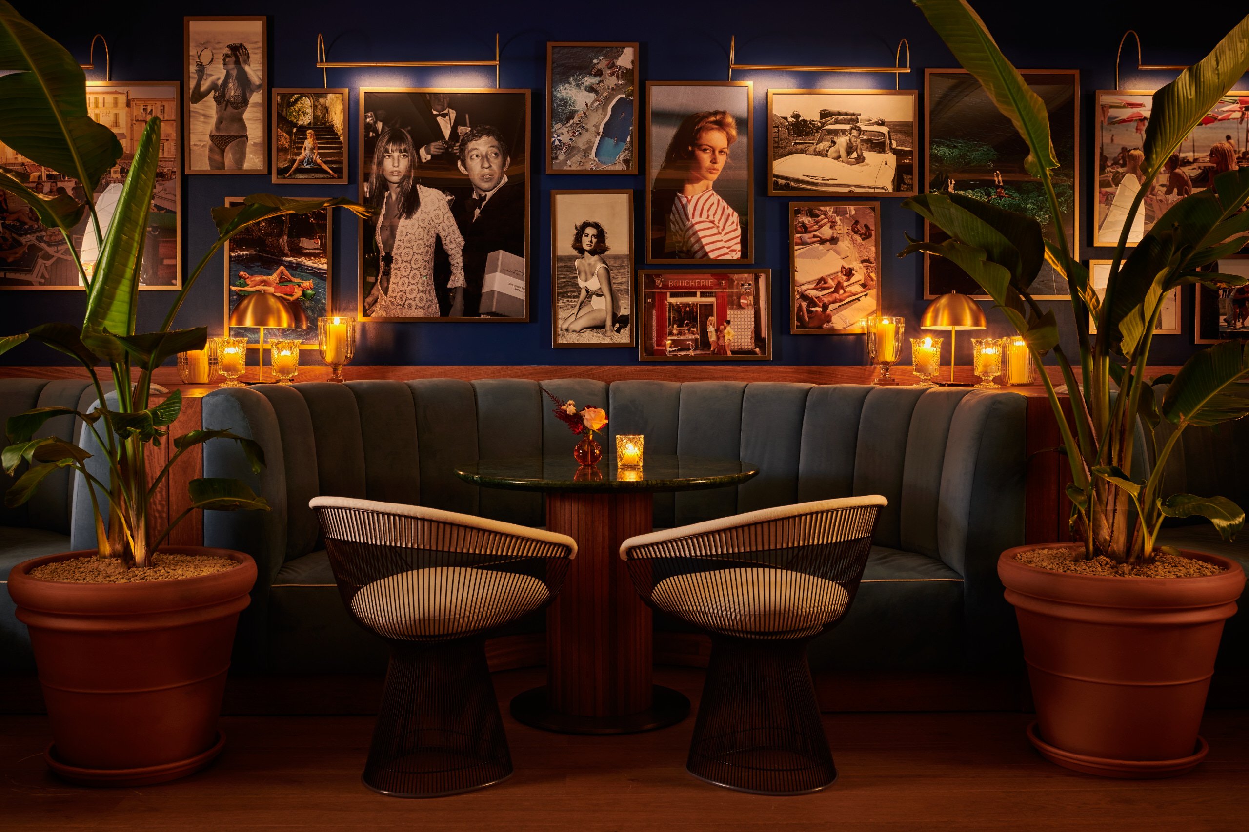 Intimate bar seating beneath a gallery wall of photographs