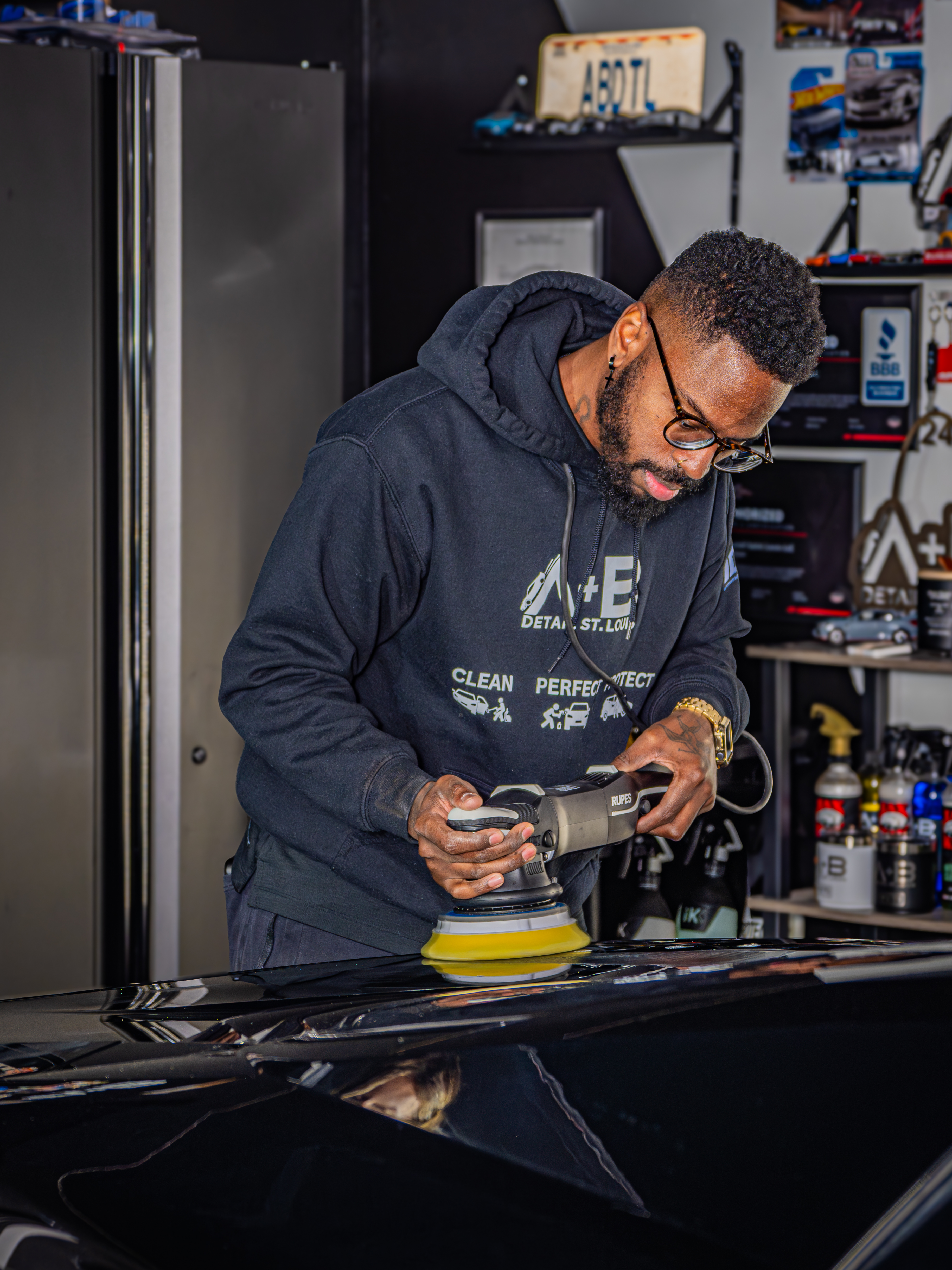 Anthony Meyer polishing a vehicle at A+B Detail St. Louis