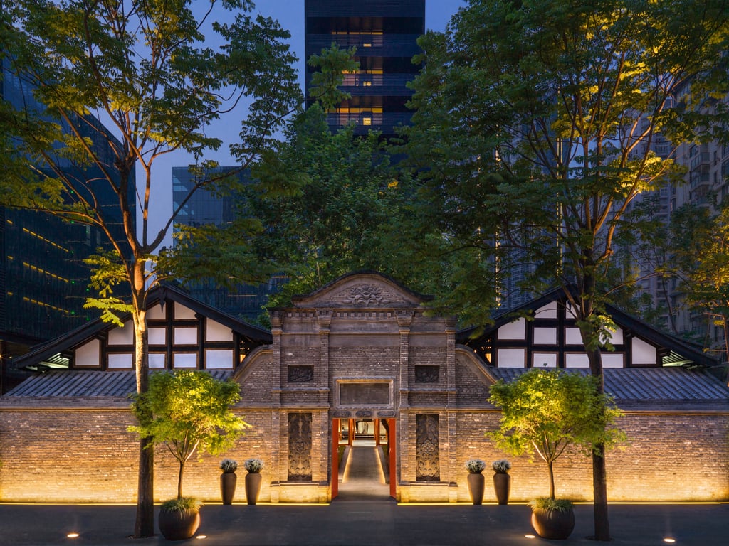 Historic stone entrance of The Temple House illuminated at dusk