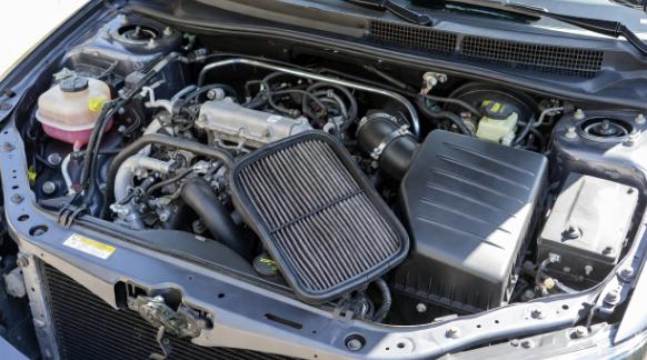 Car engine bay with air filter housing open