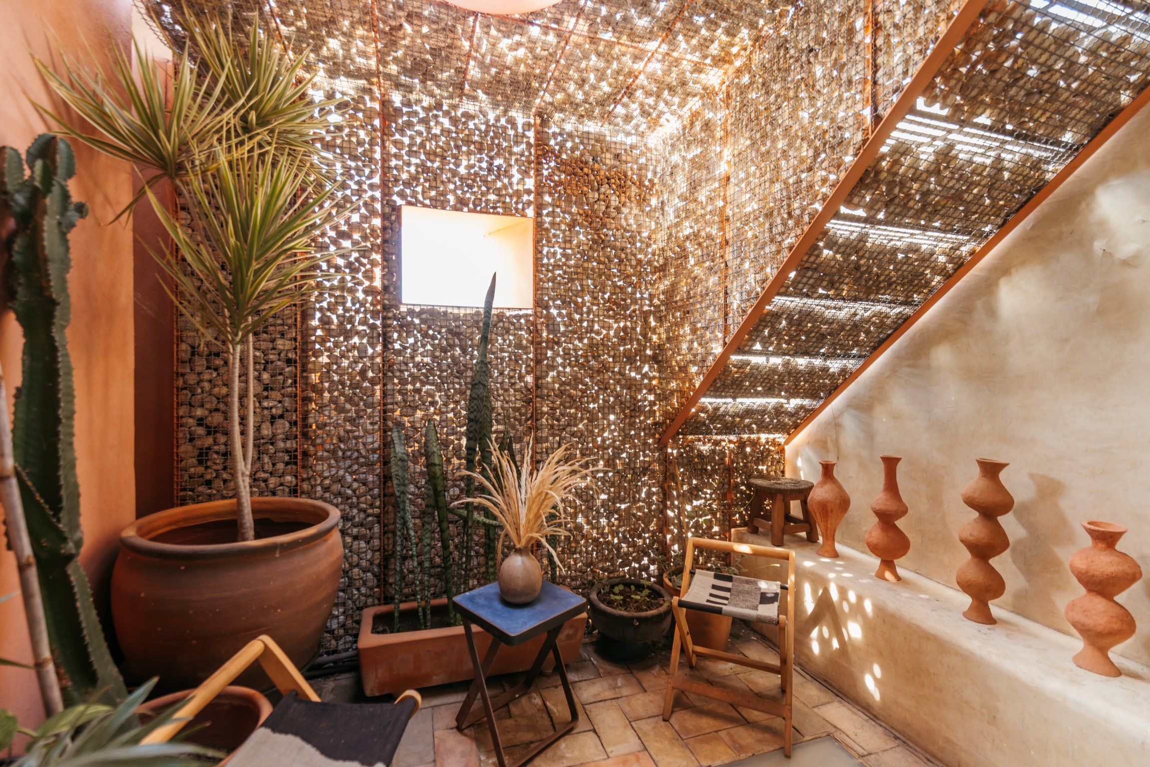 Sunlit courtyard and perforated stair screen at Boulenc Bed and Bread