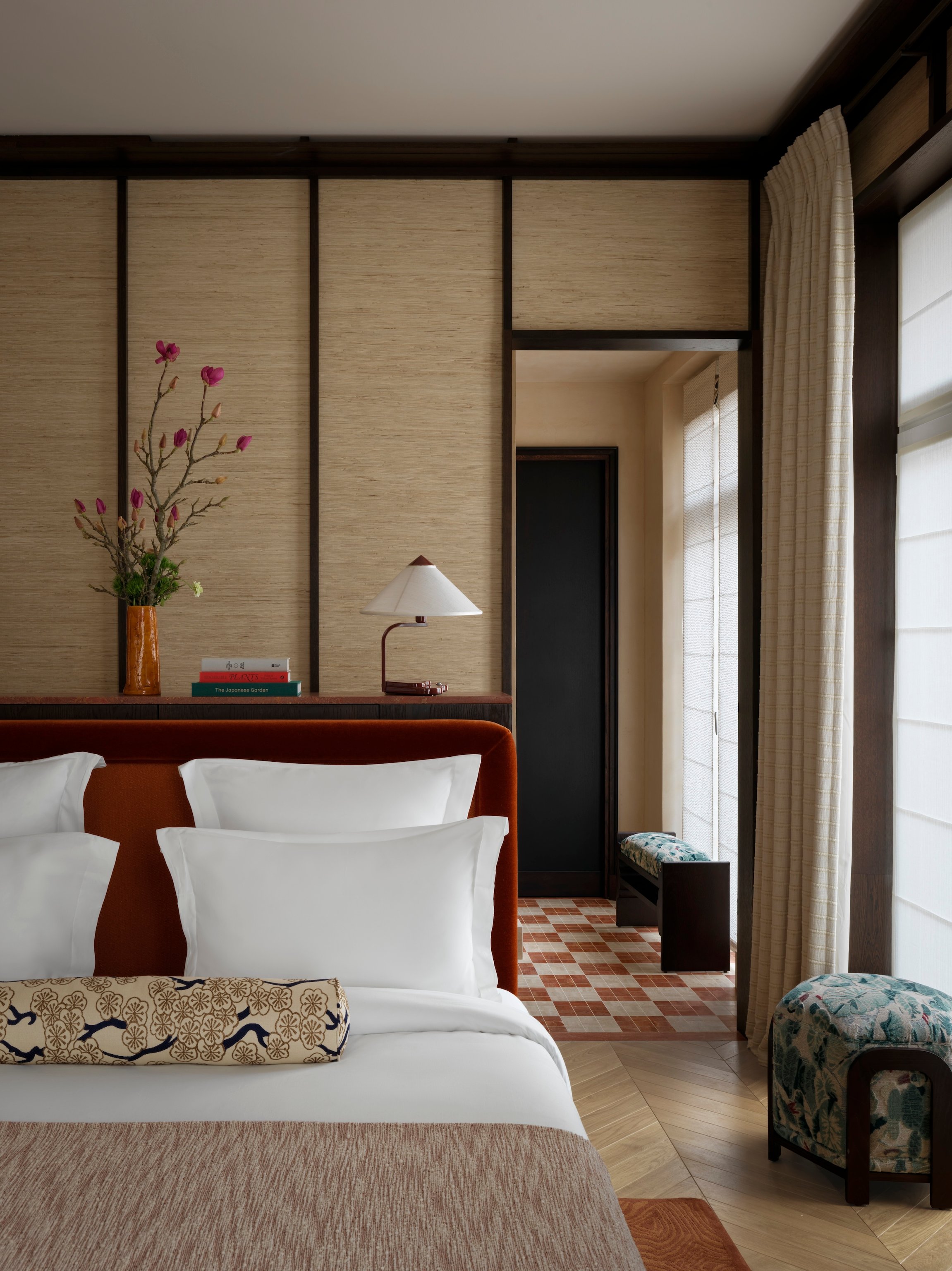Hotel Hana bedroom with Japanese-inspired panels and a padded headboard