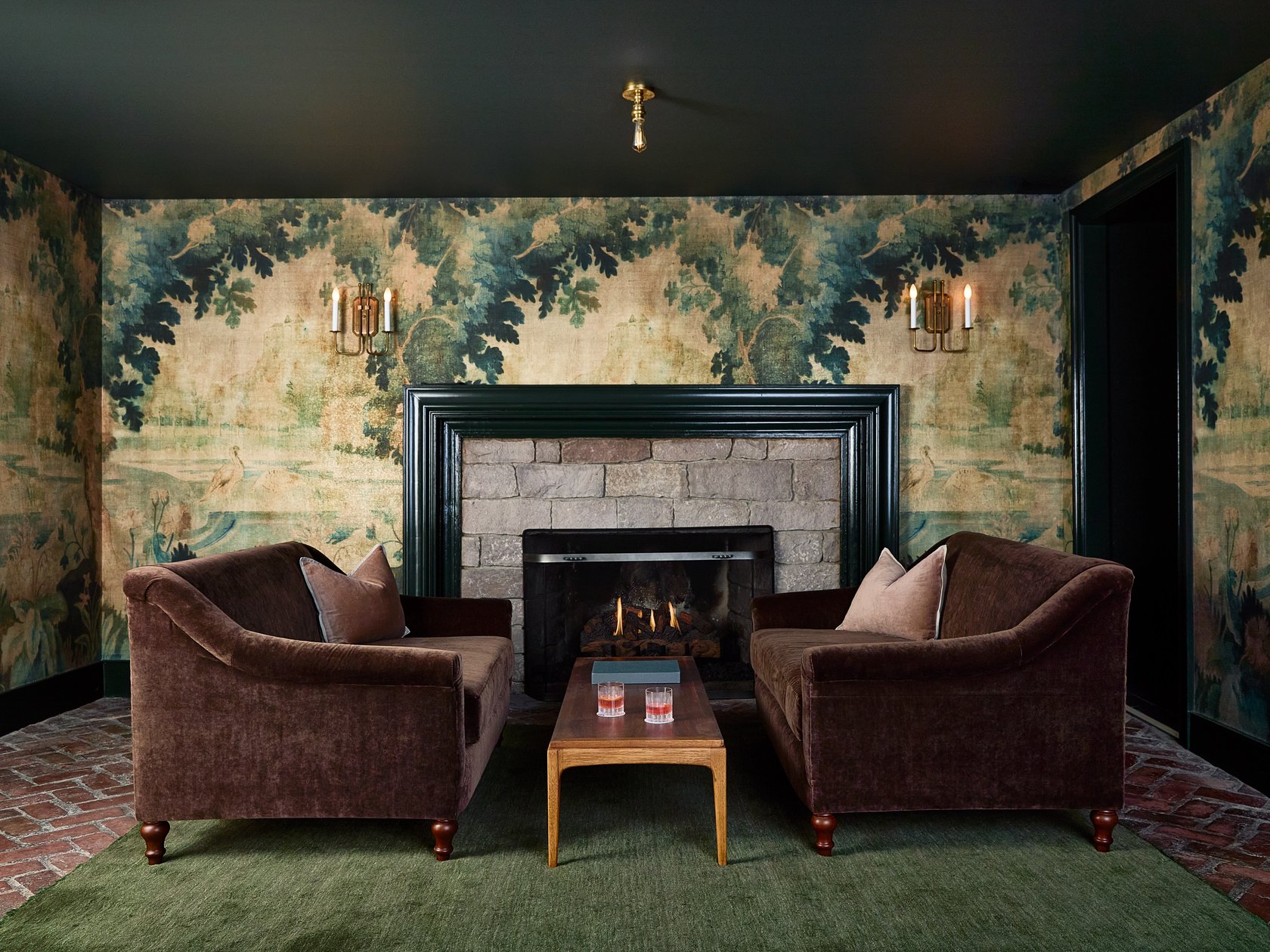 Stockton Inn lounge with a fireplace and woodland wallpaper