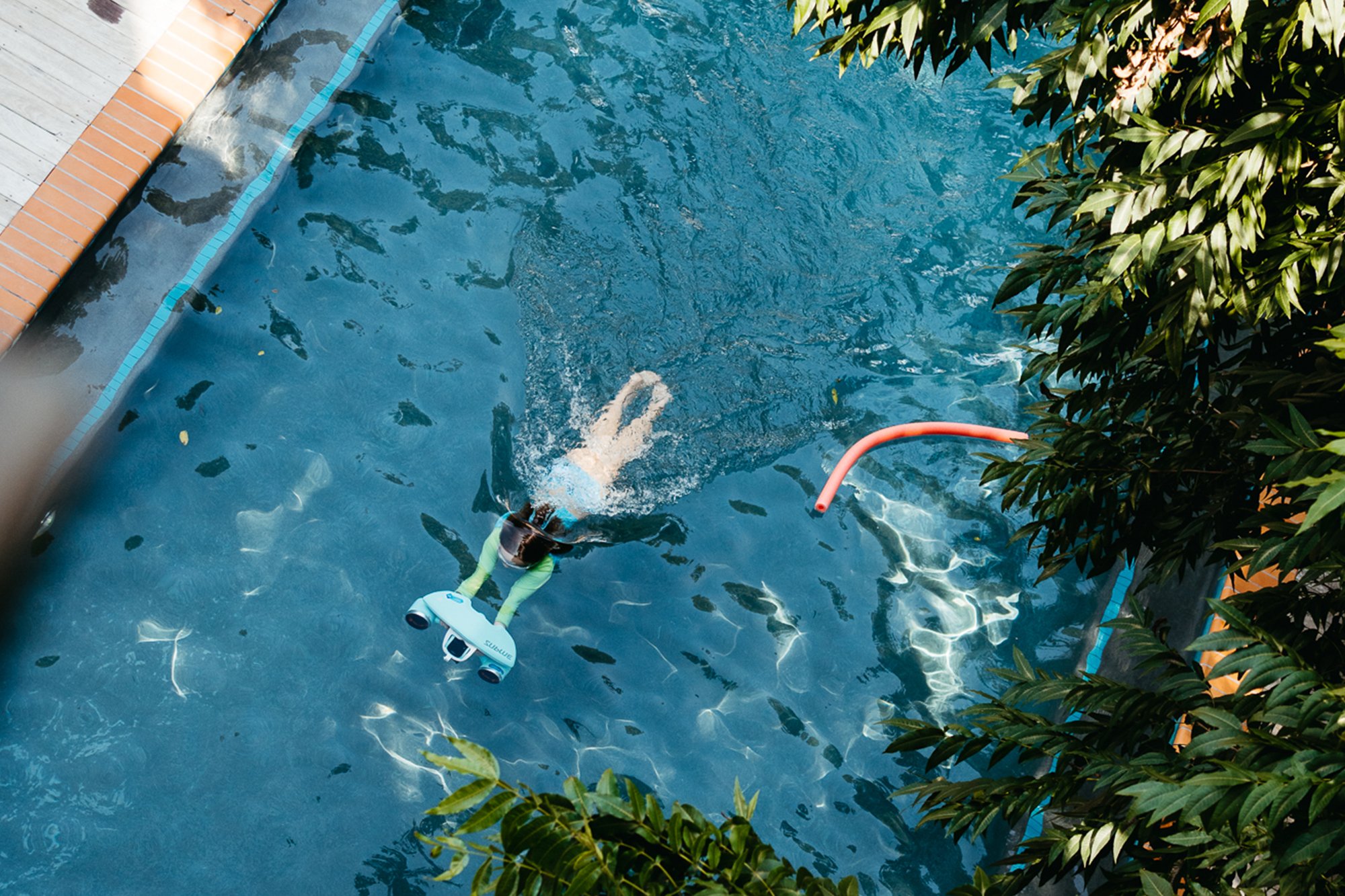 Overhead view of a swimmer in Carpenter Hotel’s outdoor pool
