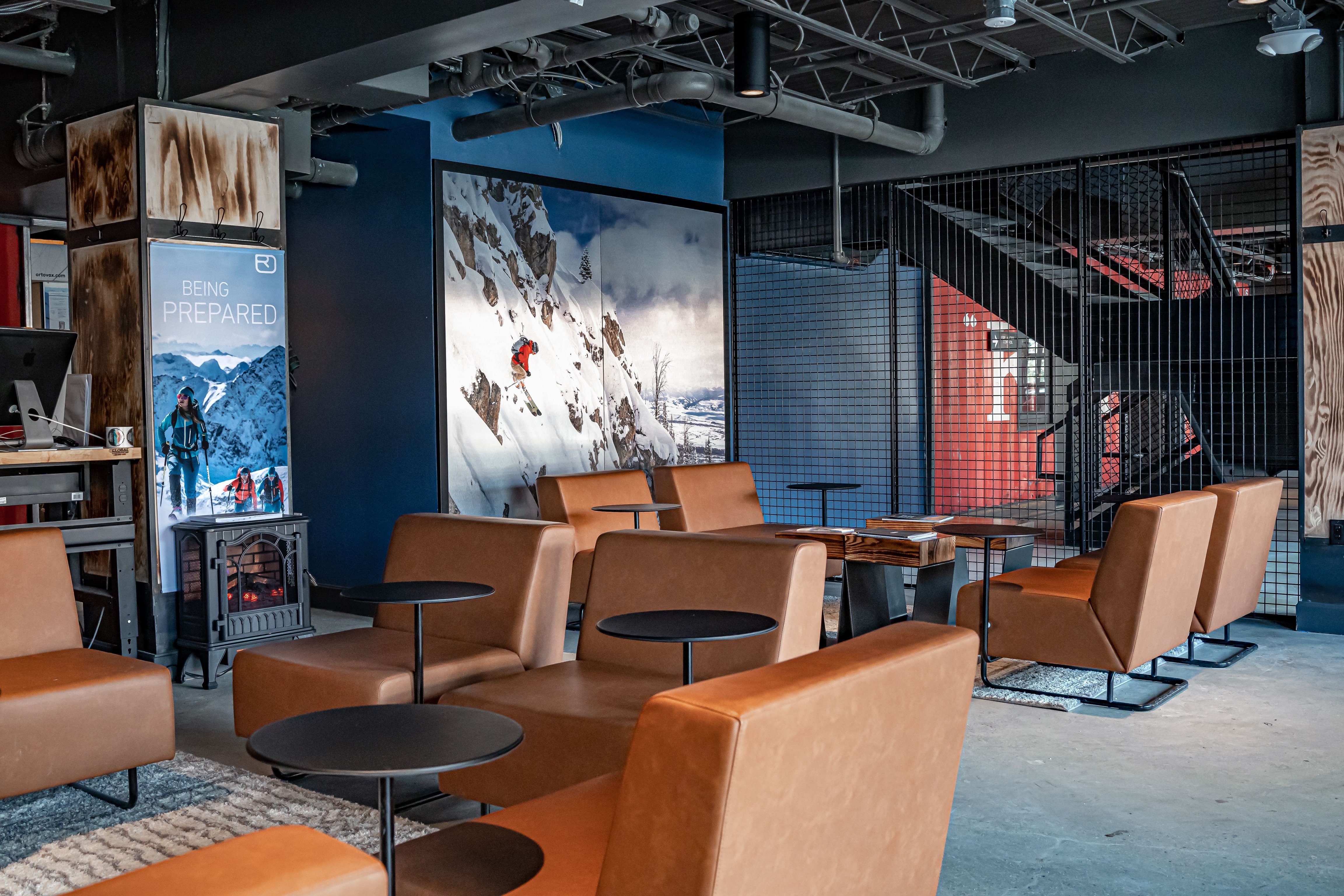 Leather lounge chairs and mountain artwork at Gravity Haus Breckenridge