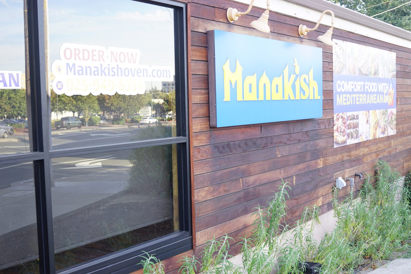 The blue and yellow Manakish sign on the wood-sided storefront at 2905 N. Main St. in Walnut Creek.