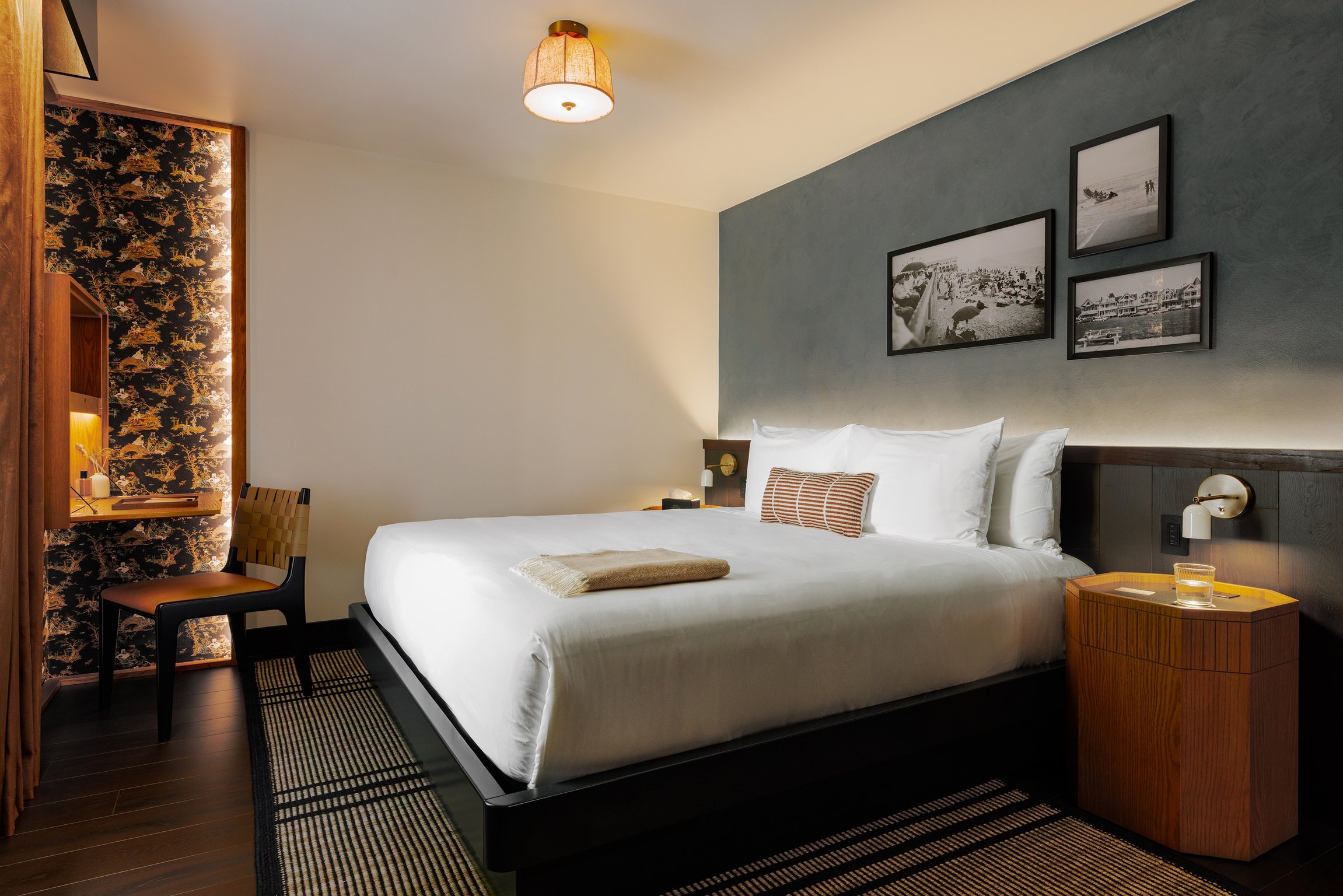 Hotel Albatross guest room with a blue accent wall and framed artwork