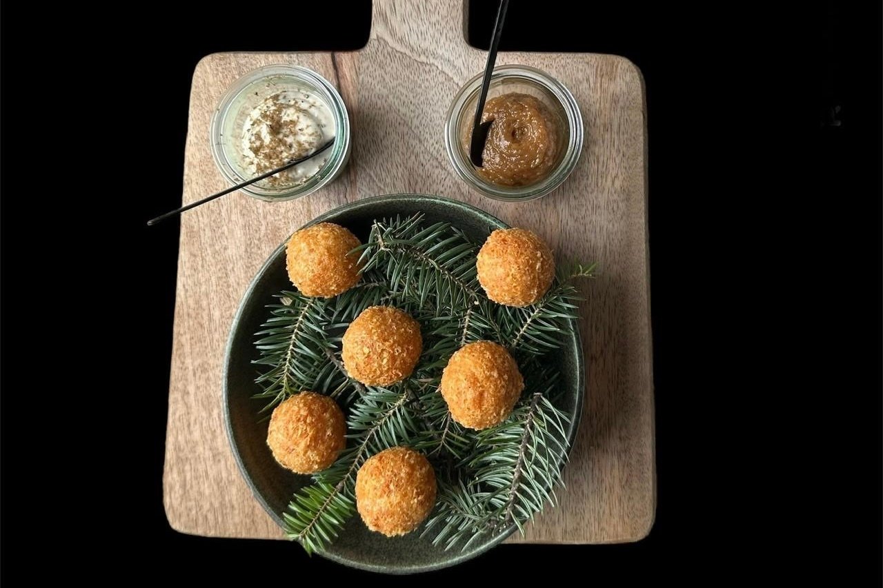 Overhead plate of golden croquettes with two dipping sauces