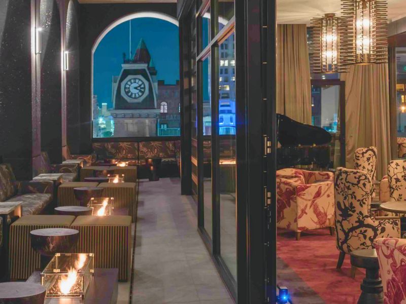 Rooftop terrace with fire pits and lounge seating at Hotel Bourré Bonne
