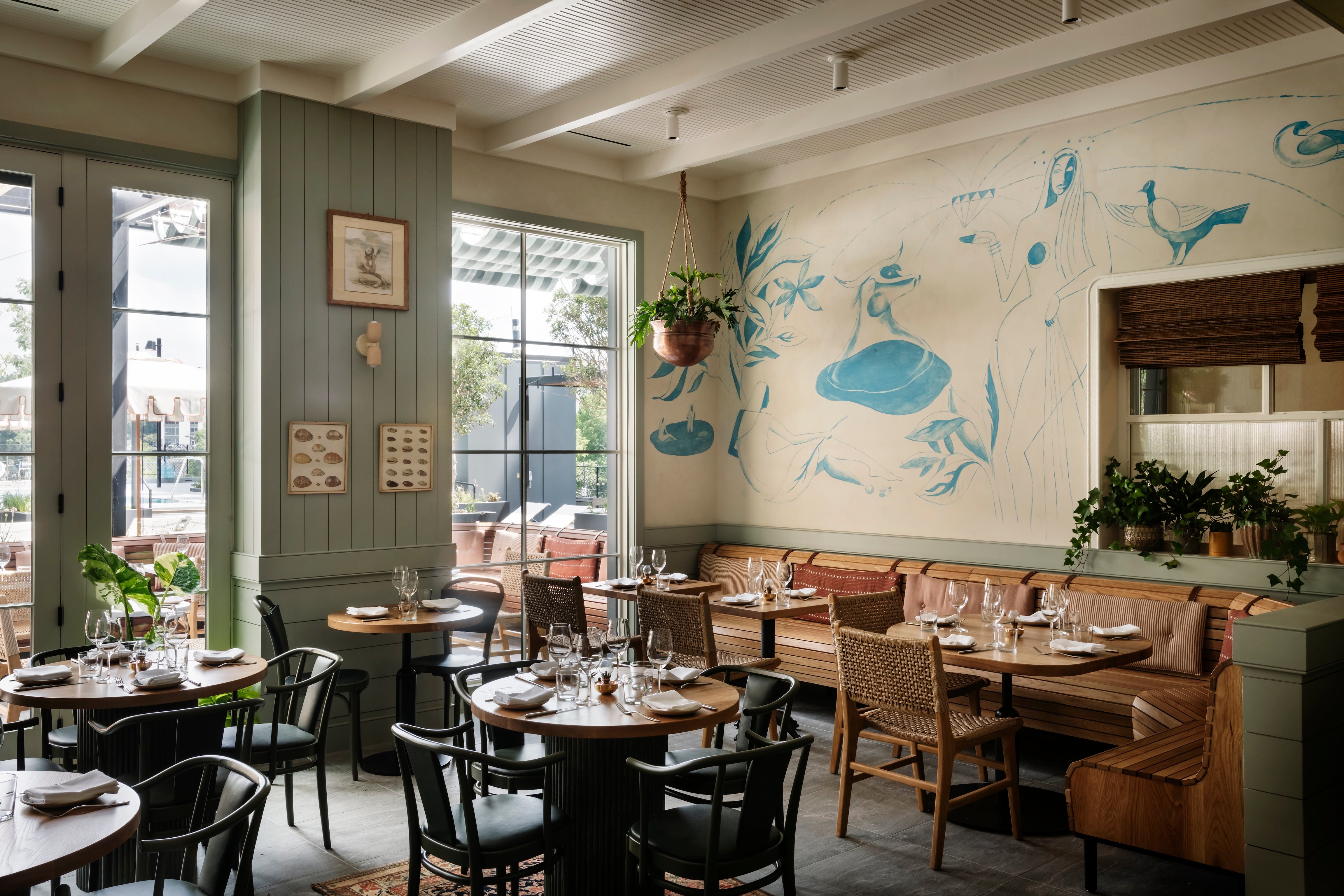 Bright dining room with illustrated walls at Forth Atlanta