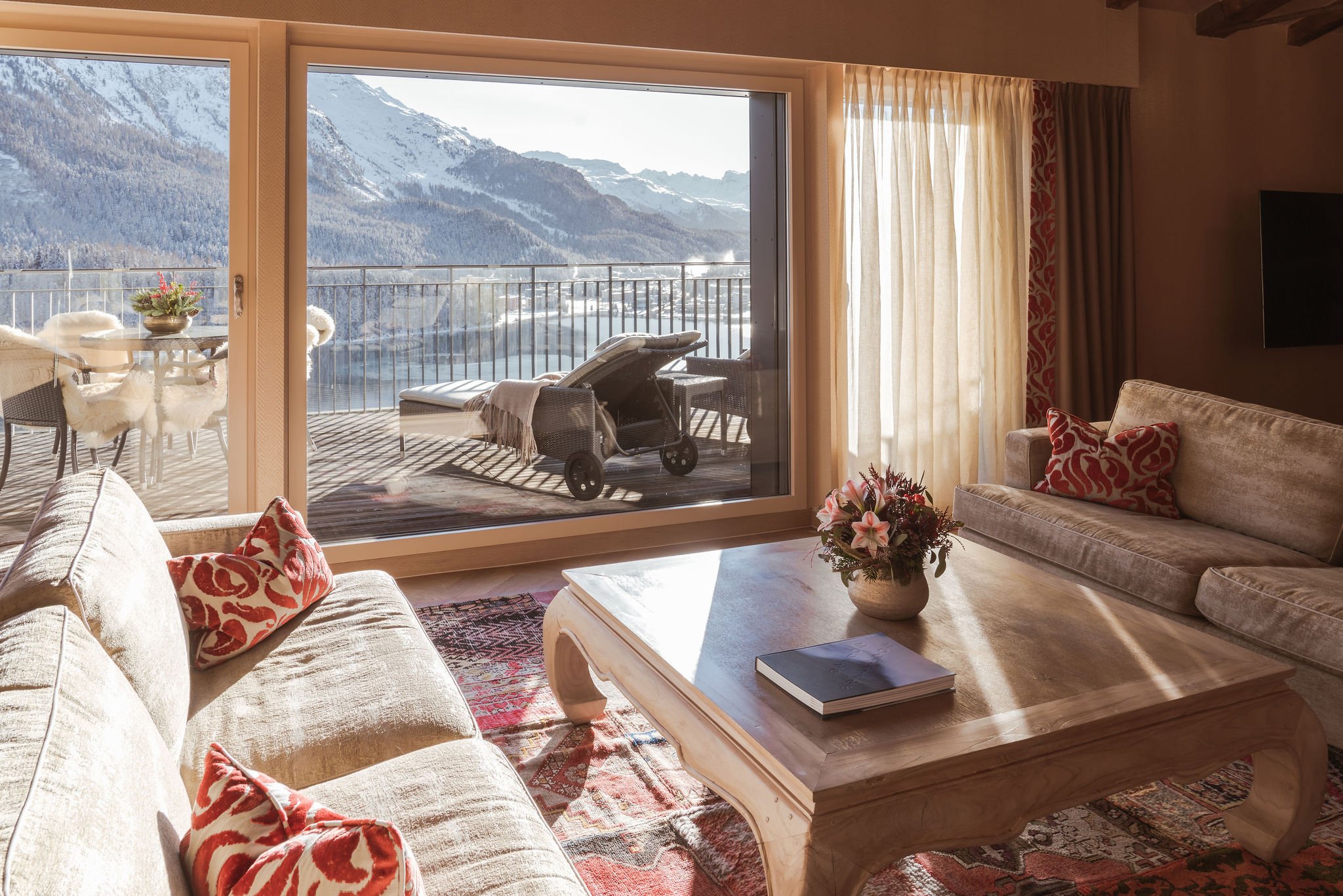 Suite living room and terrace overlooking Lake St. Moritz