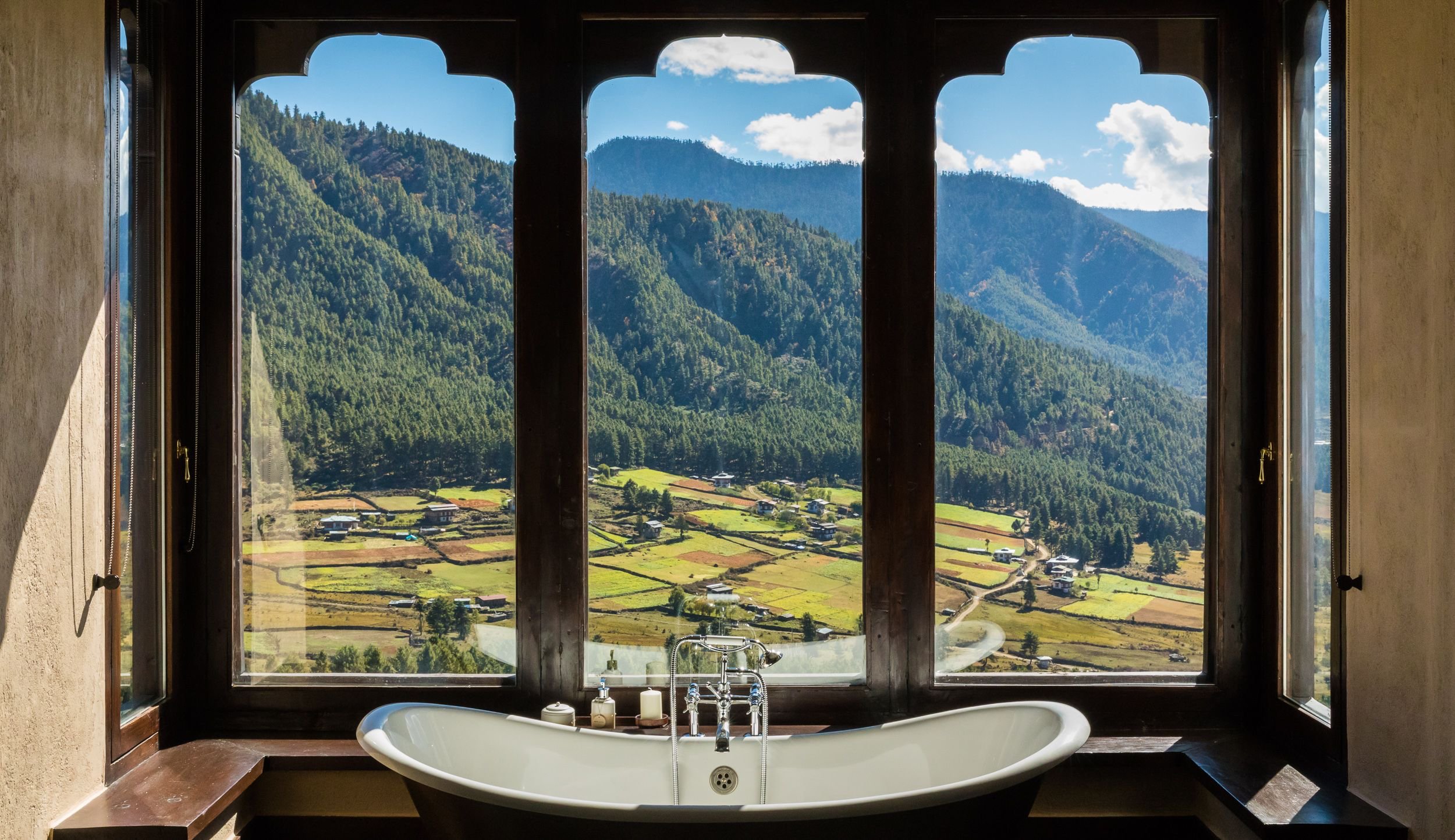 Freestanding bathtub overlooking Bhutan’s Phobjikha Valley at Gangtey Lodge