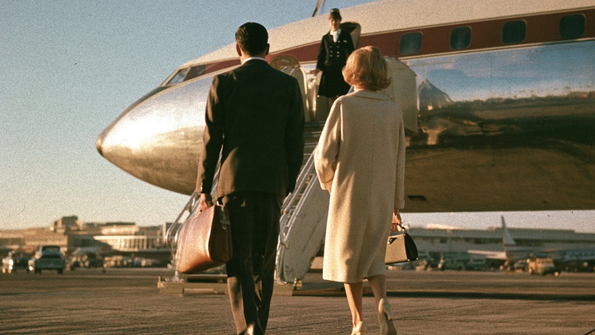 A glamorous 1960s airline cabin with passengers in formal dress