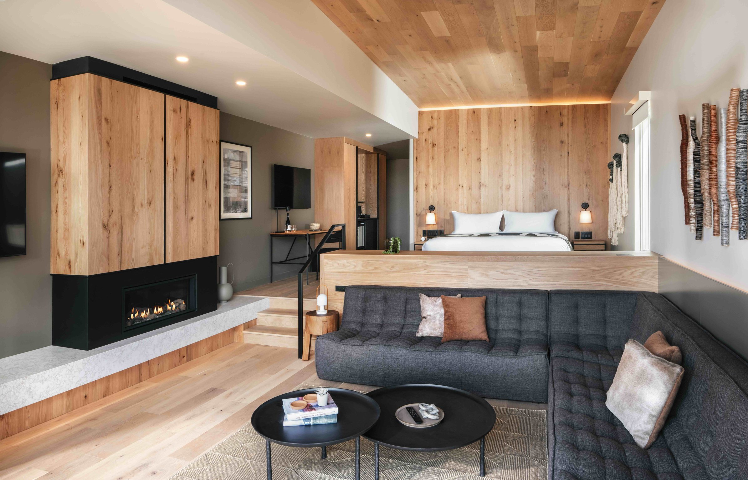Modern bungalow with wood finishes, fireplace, and lounge seating