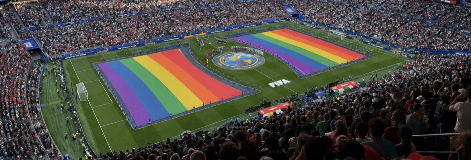 Rainbow Pride flags lying impossibly flat on a soccer field that AI imagined into existence