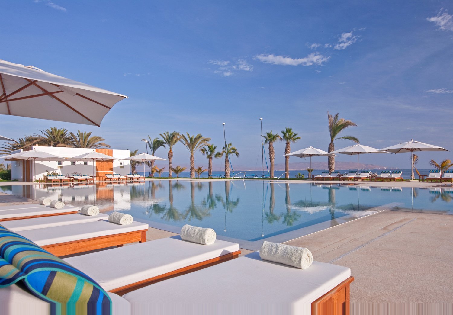 Oceanfront swimming pool and loungers at Hotel Paracas